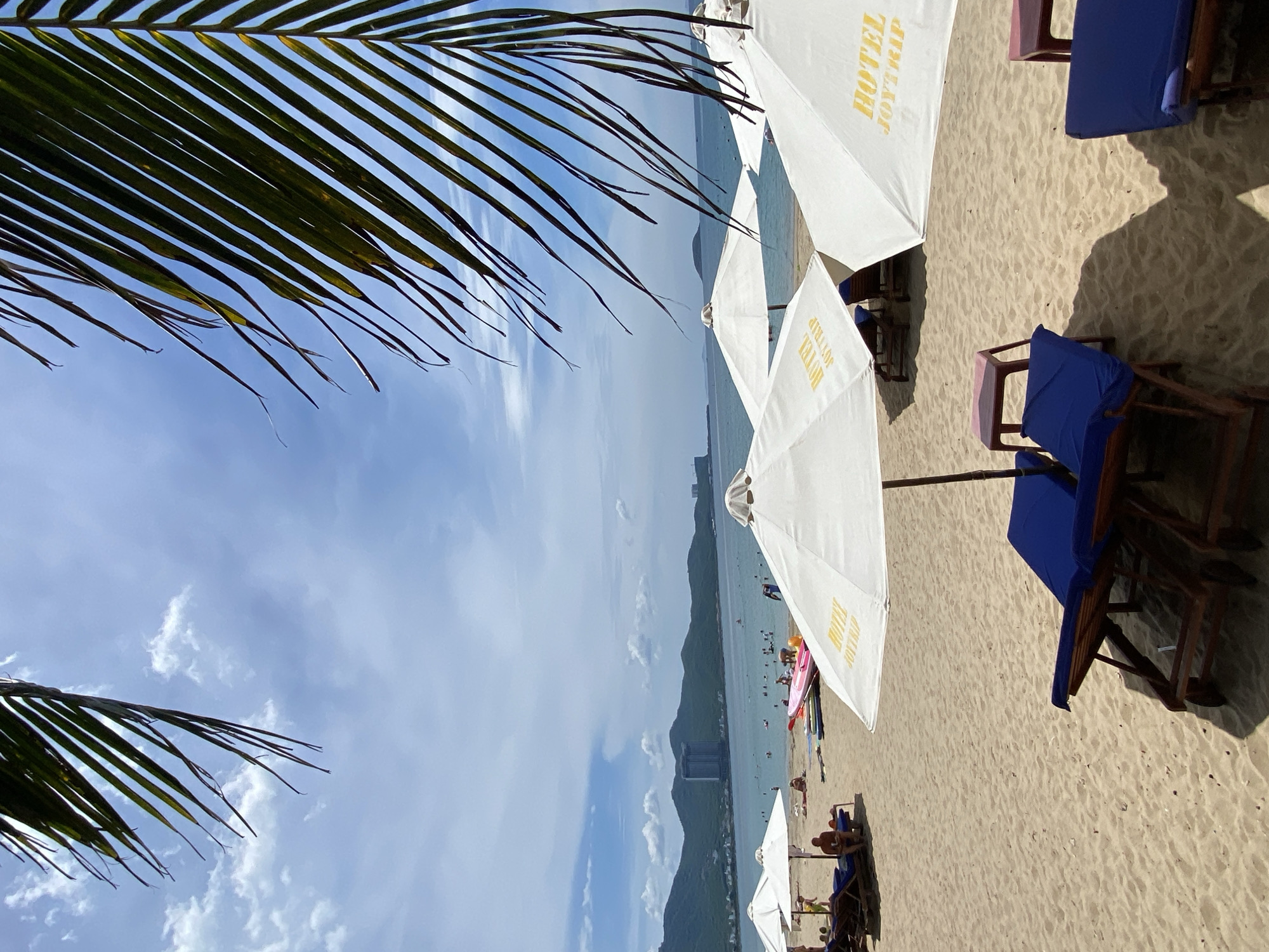 Nha Trang beachfront at dawn, vendors and locals along the shore