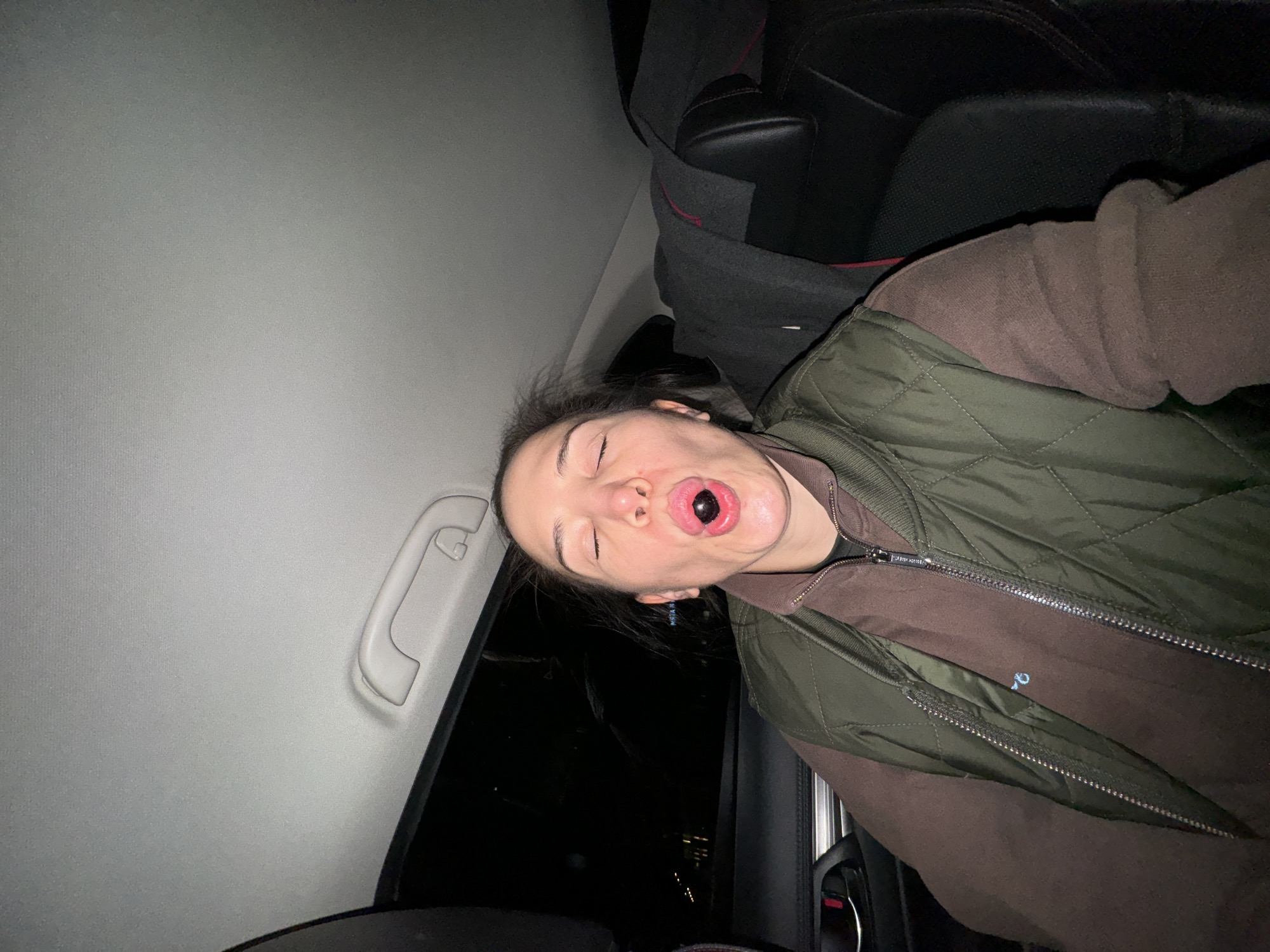 Young person photographed inside car at night in Moscow