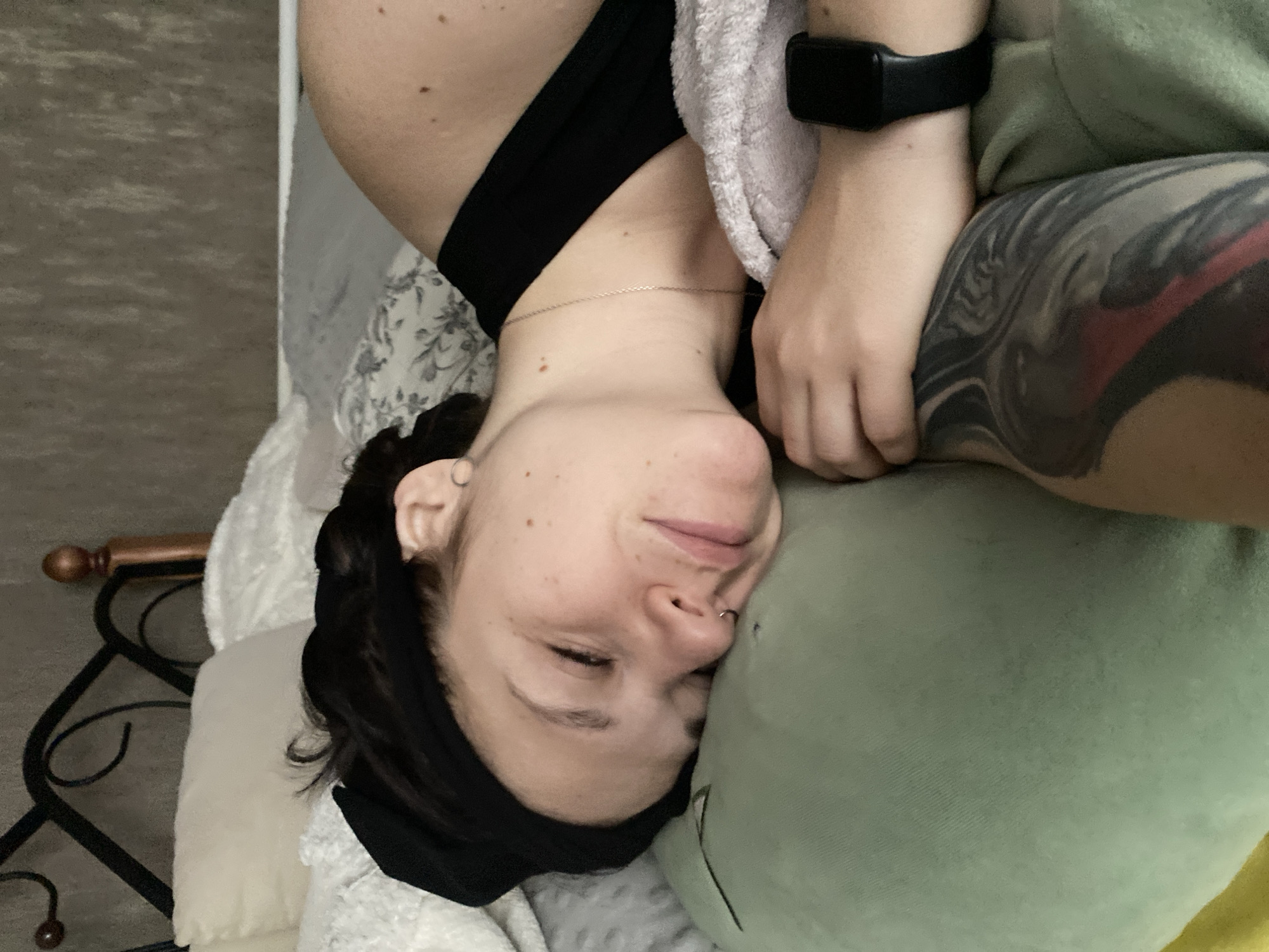 Person relaxes in bed with cat in Chaikovsky