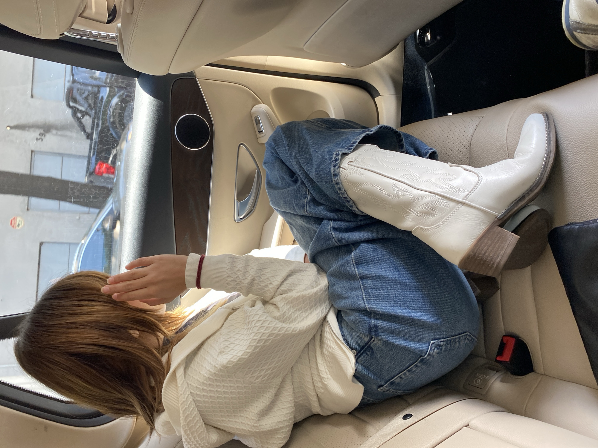 Woman relaxes in luxury car backseat in Mexico City