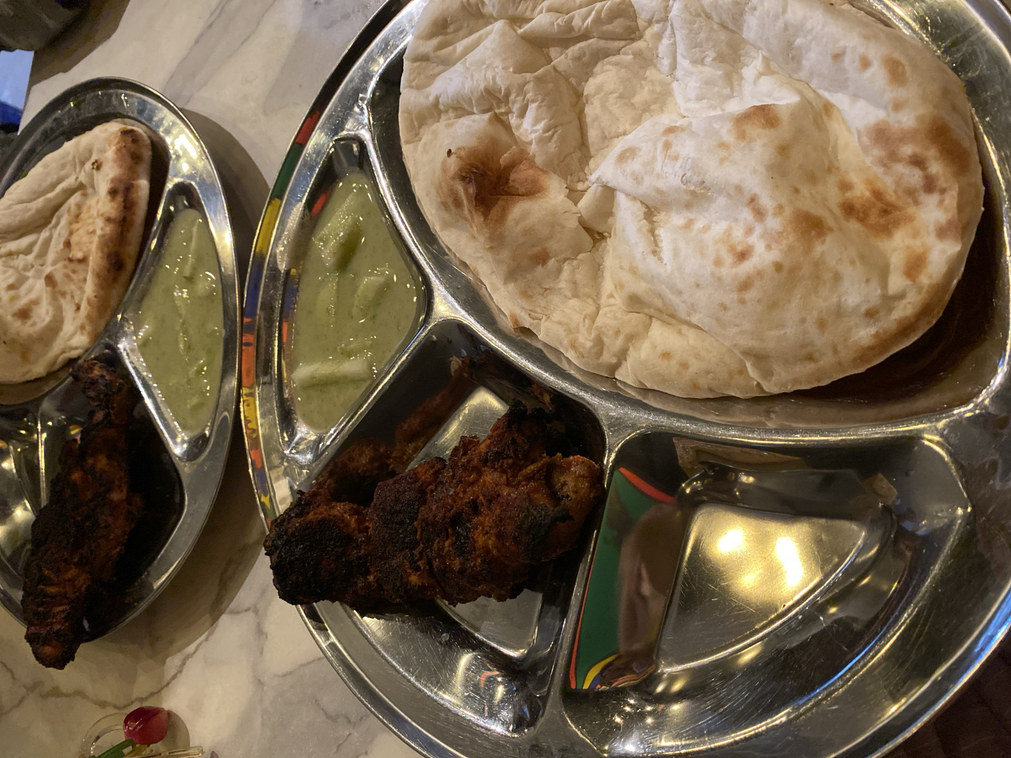 Traditional meal served in metal trays at Dhaka restaurant