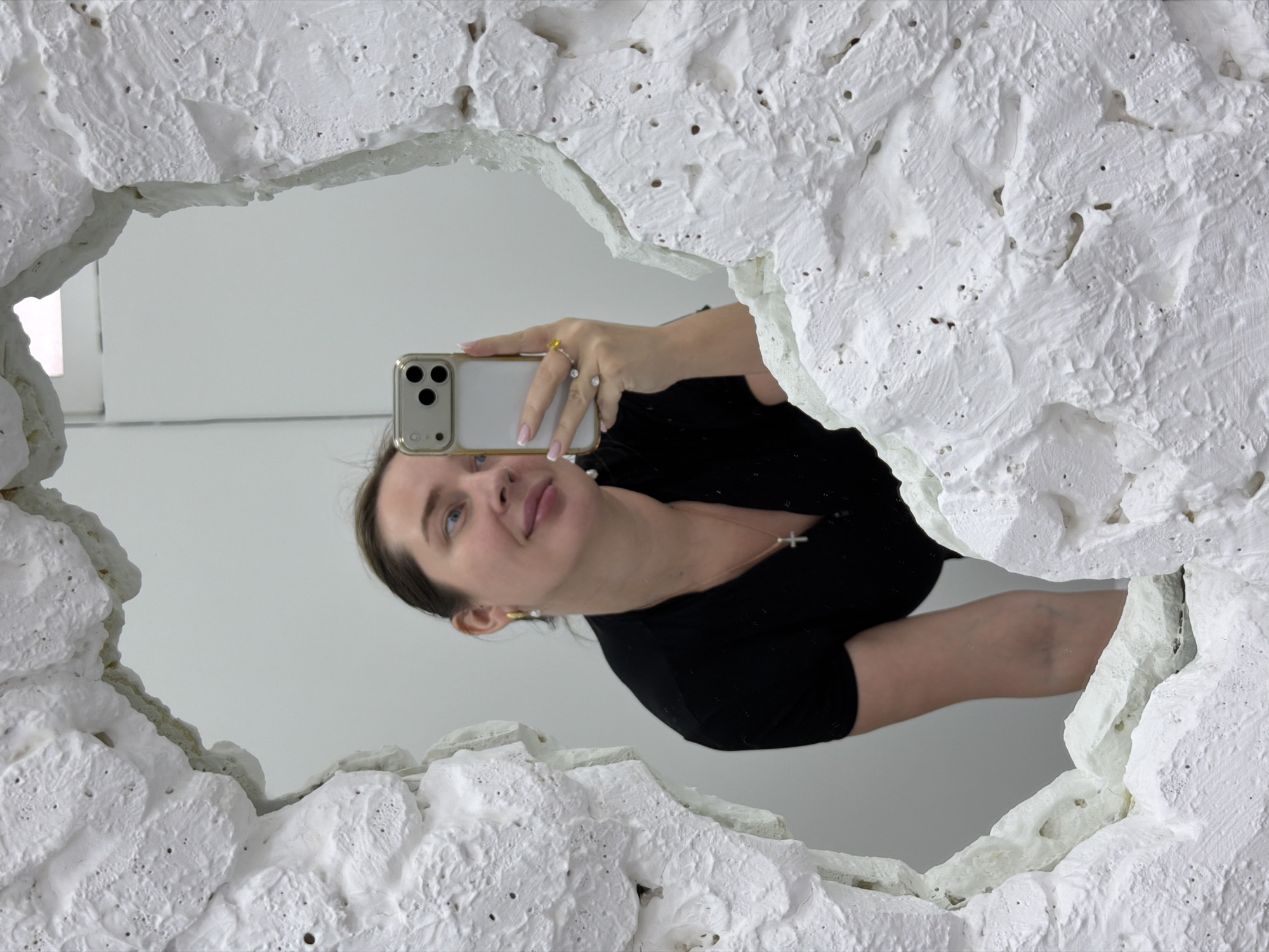 Woman takes mirror selfie in Moscow interior space