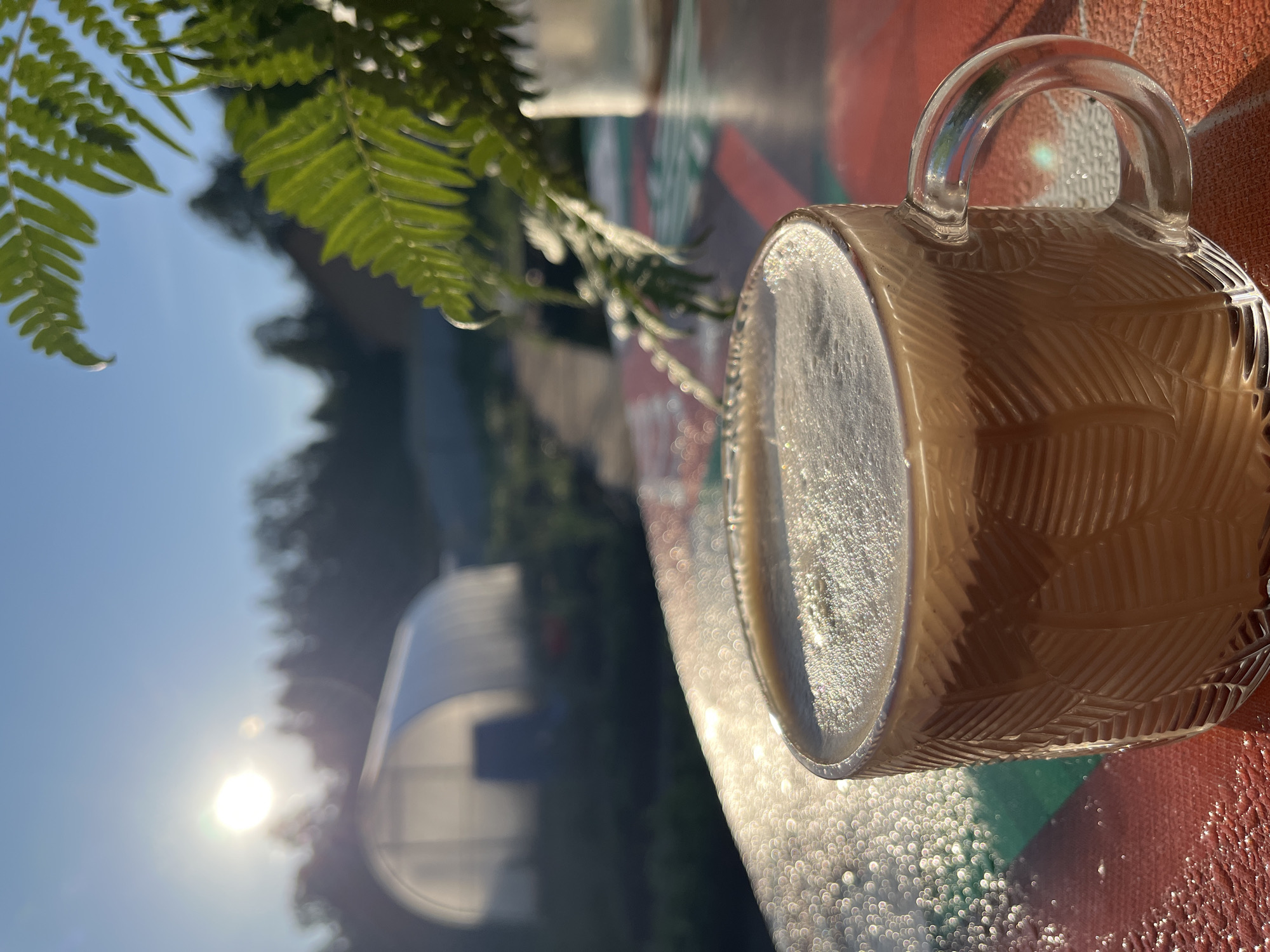 Orange-haired person enjoys morning drink outdoors in Chaikovsky, Russia