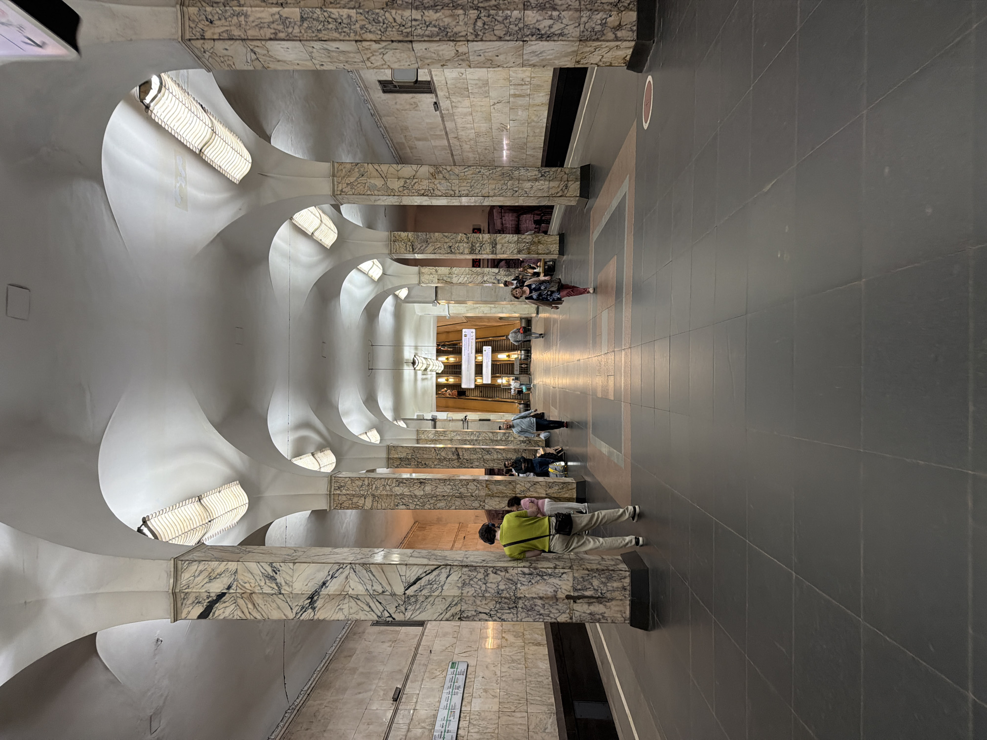 Inside a grand metro system, passengers move through ornate stations