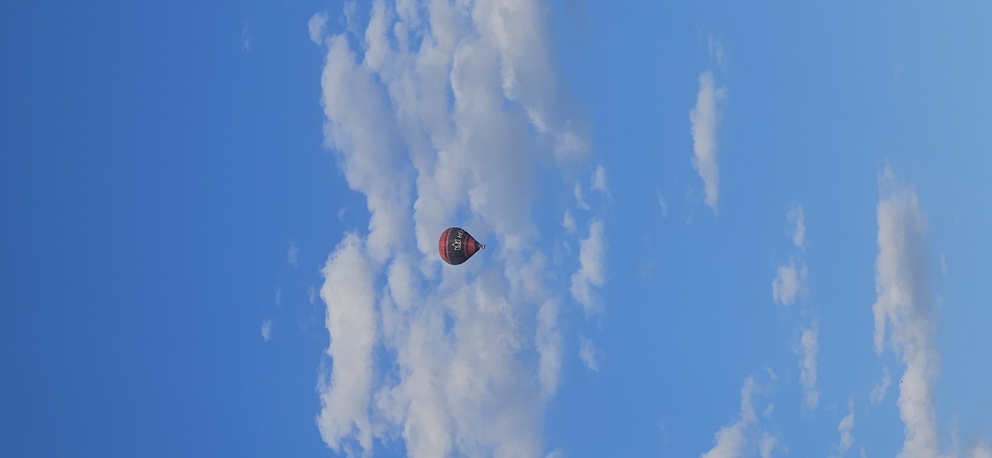 Hot air balloon rises over Hévíz on a sunny afternoon