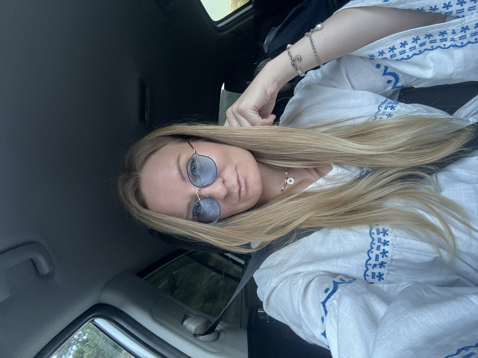 Woman takes selfie during mountain road drive