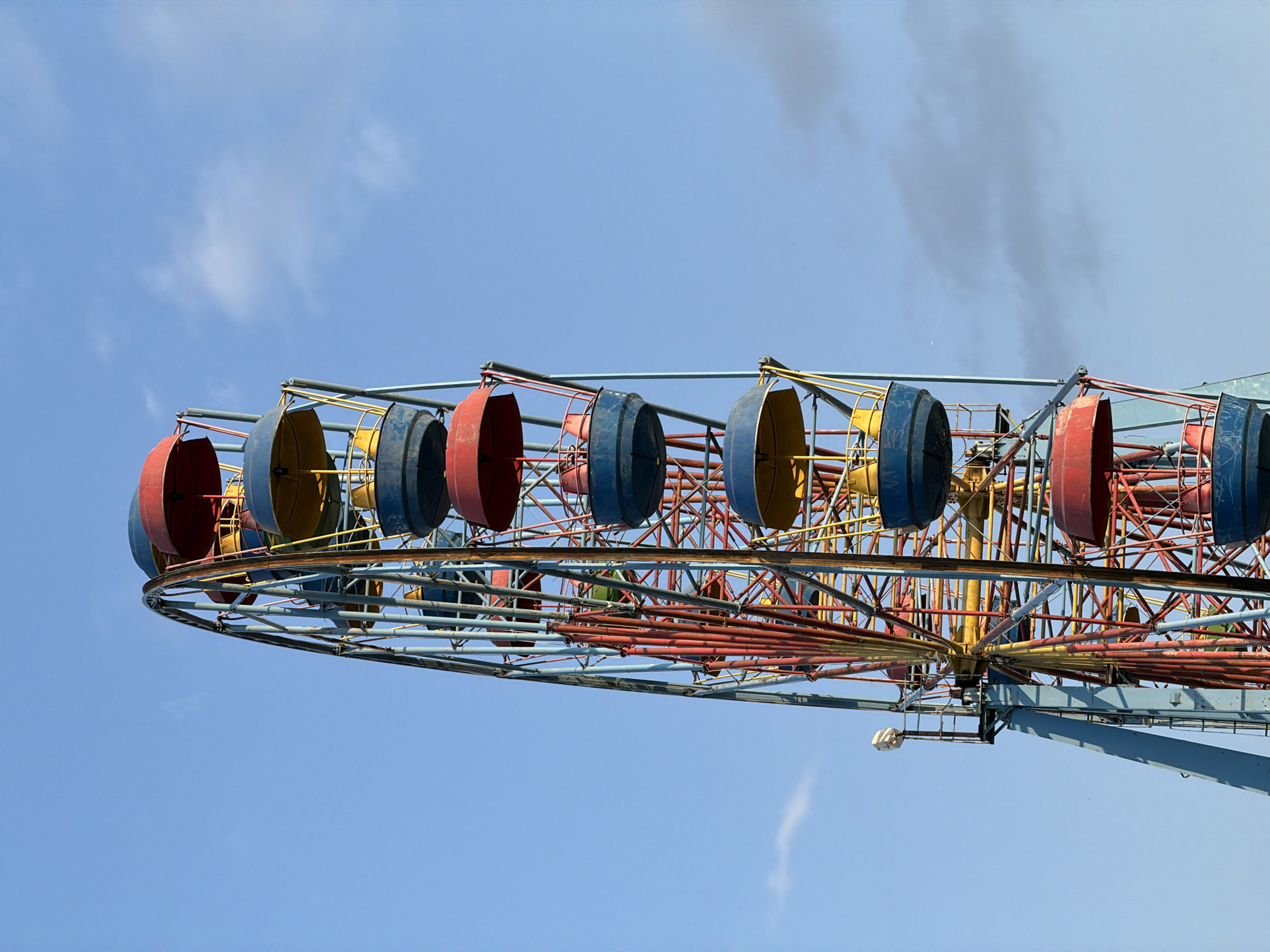 Low-angle sky views around an outdoor amusement area