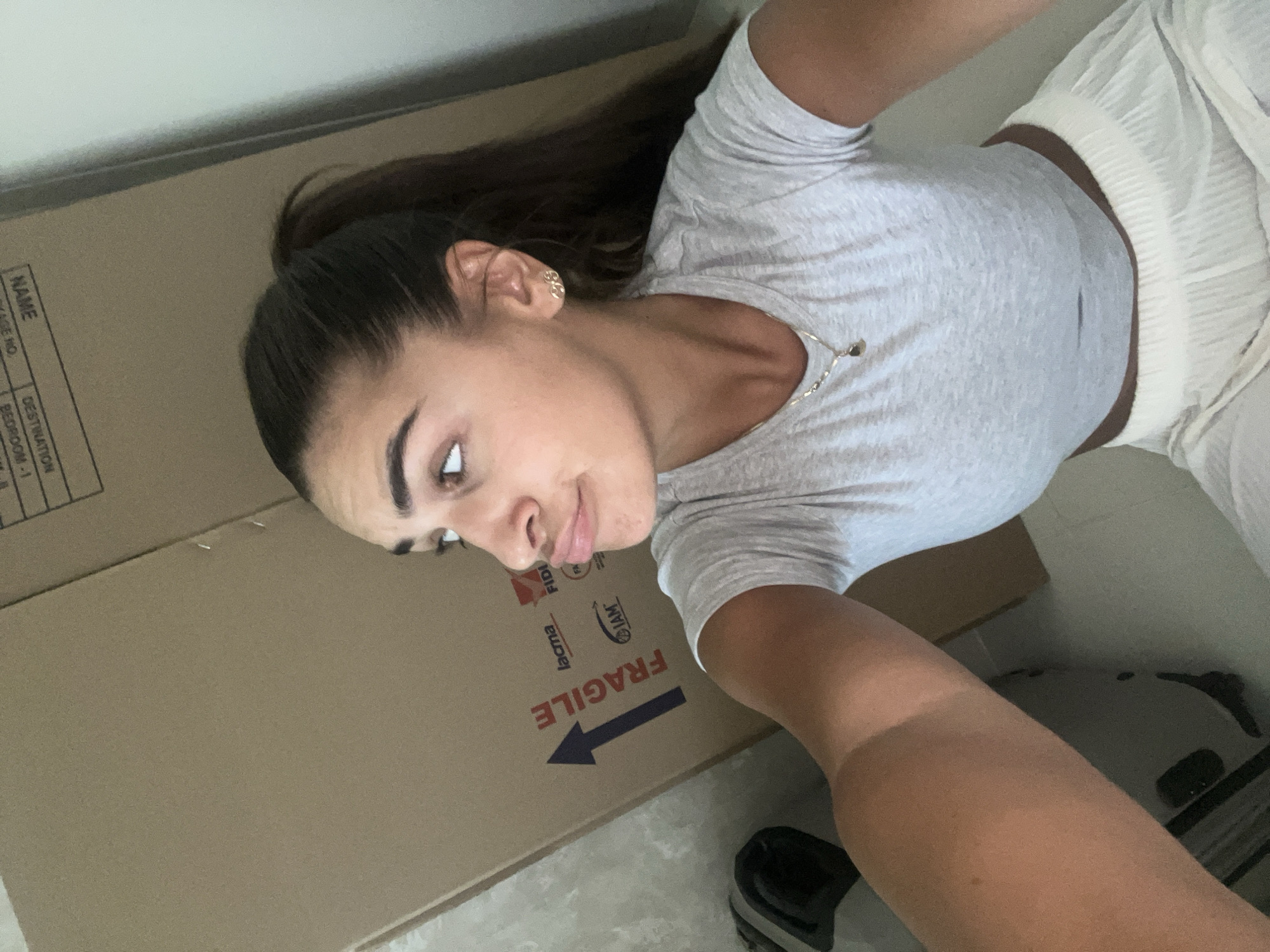 Woman poses with moving box in Dubai