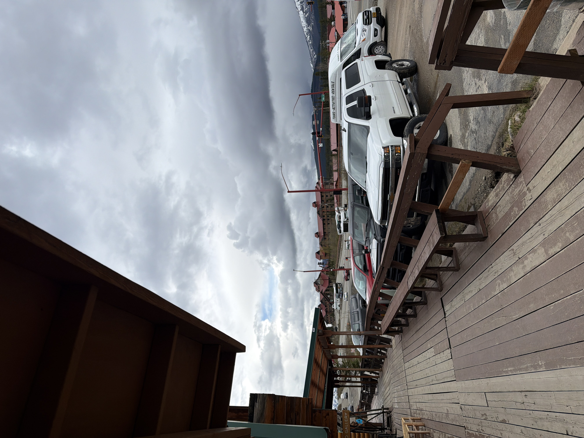 Nighttime deck view captured at Denali Park shows vehicles, buildings