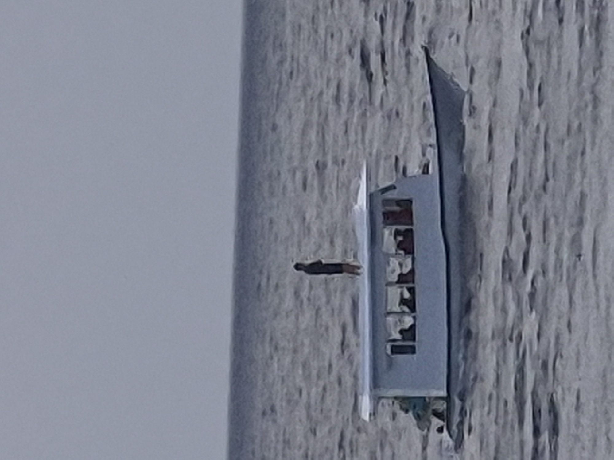 Passenger vessel sails near Huraa, Maldives shoreline