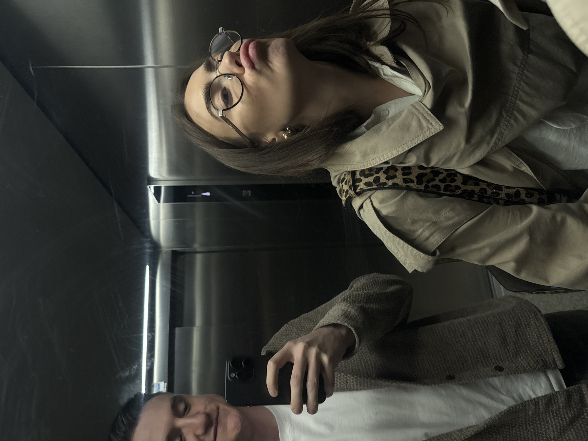 Woman in trench coat photographed in multiple interior locations