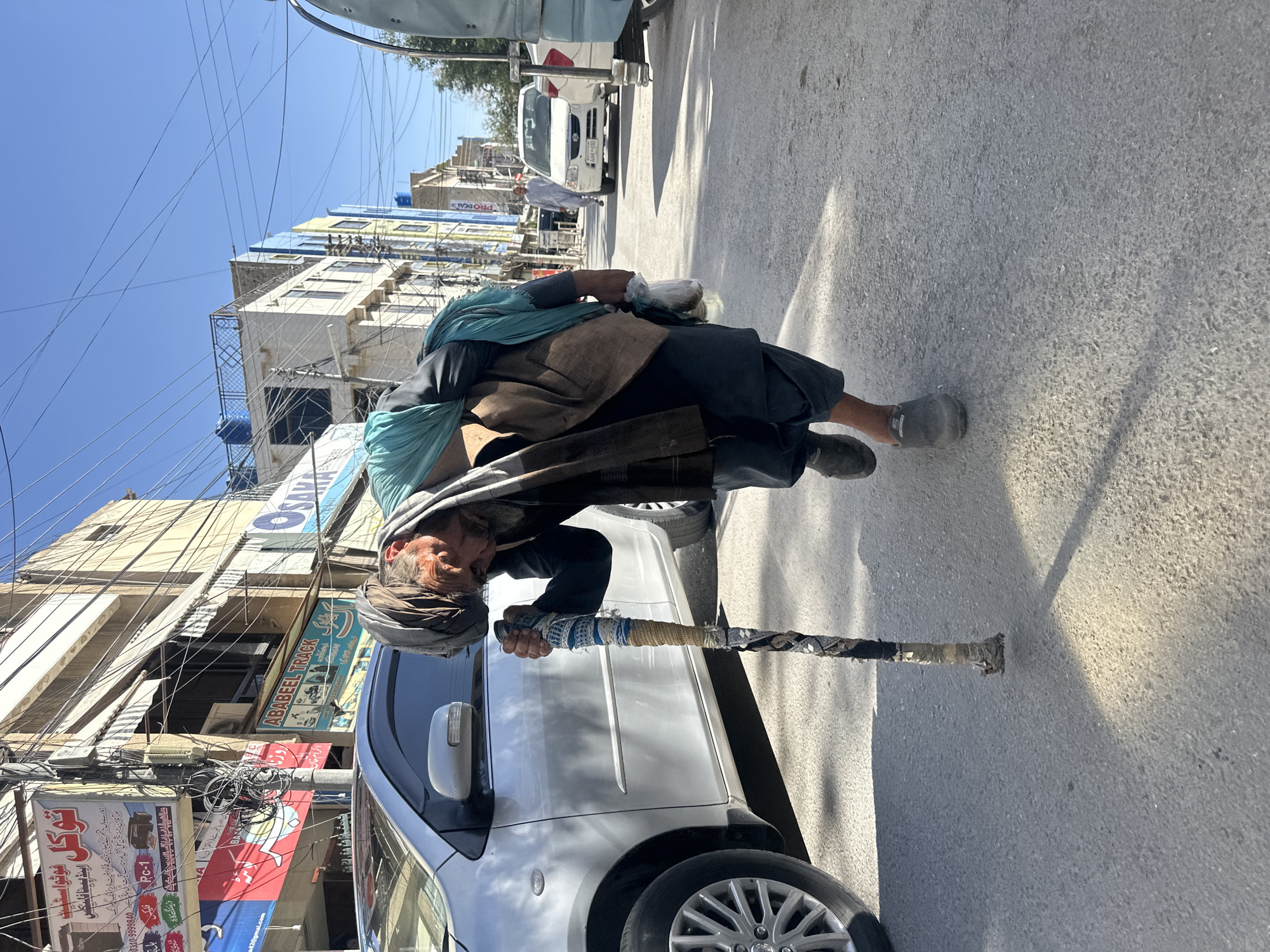 Street scenes with elderly pedestrian, banner displays in Quetta