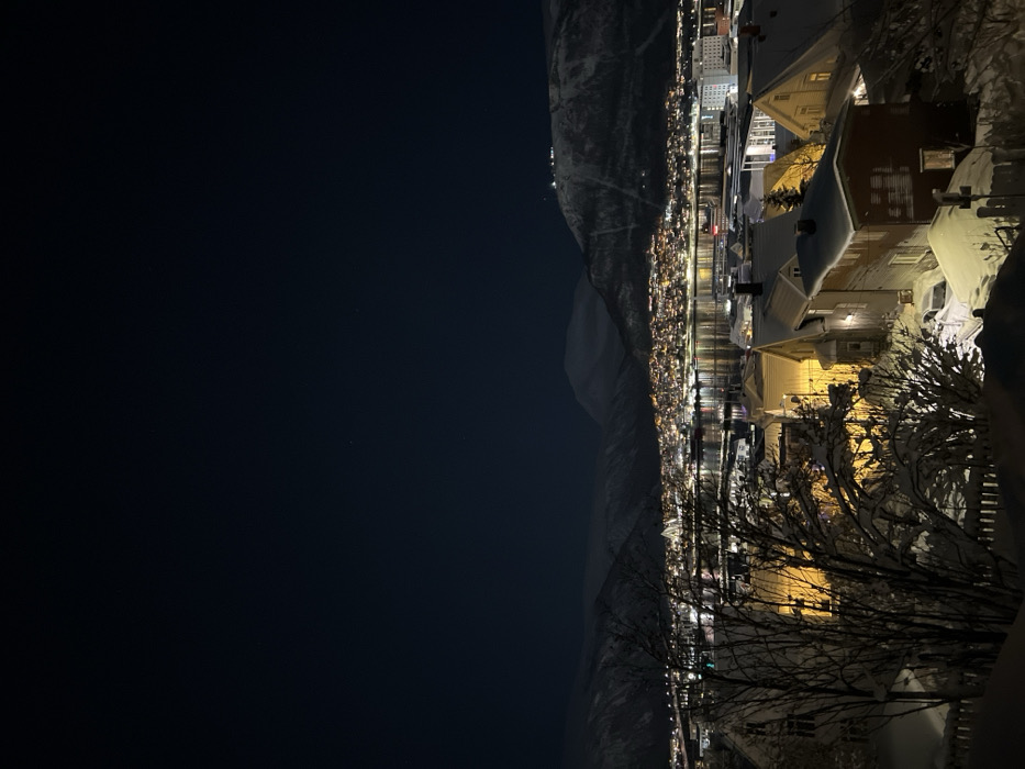 Winter night illuminates snow-covered Tromsø alongside still waters