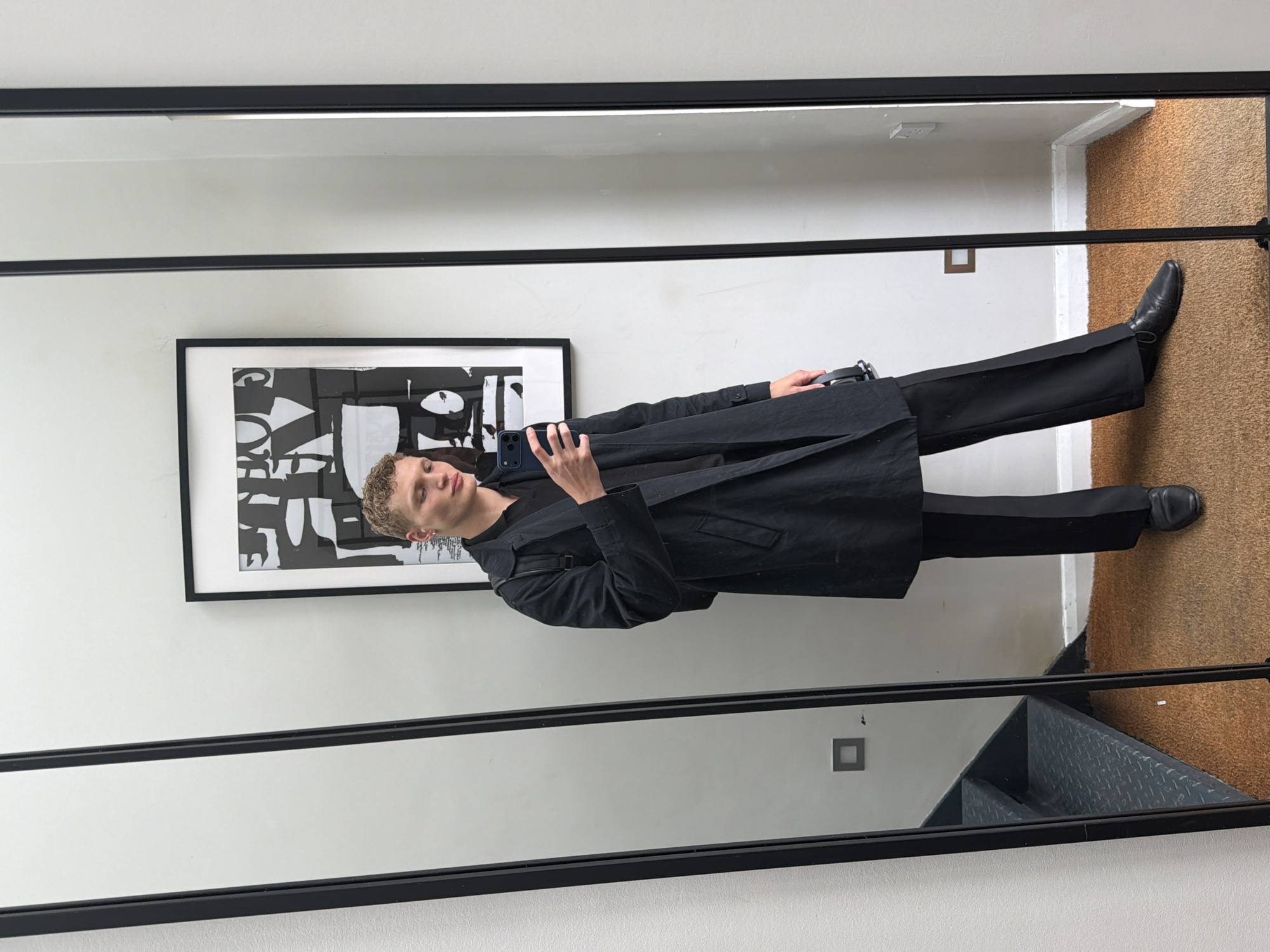 Young man takes mirror selfie indoors in London