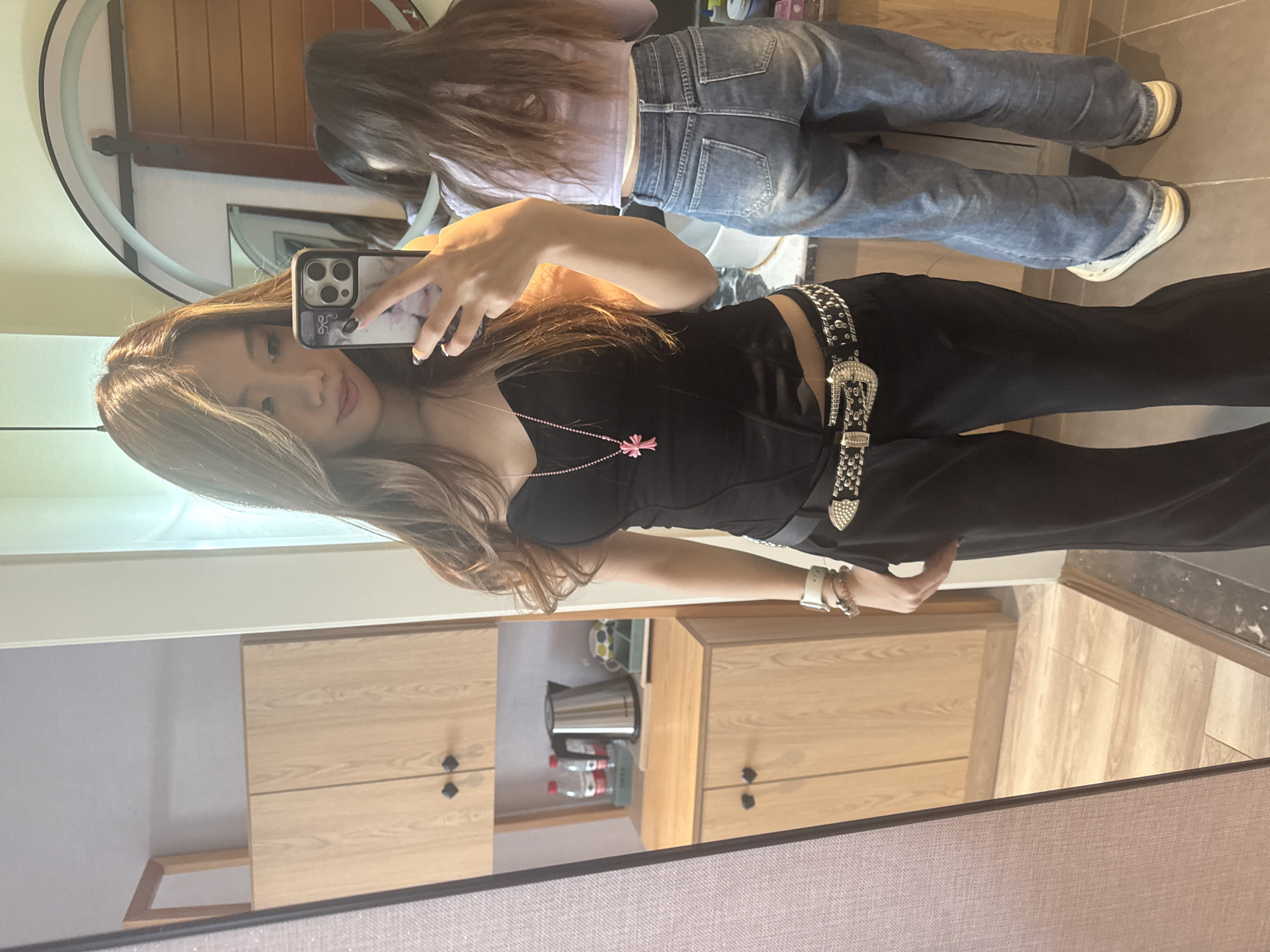 Woman takes mirror selfies in Jiayuguan hotel room