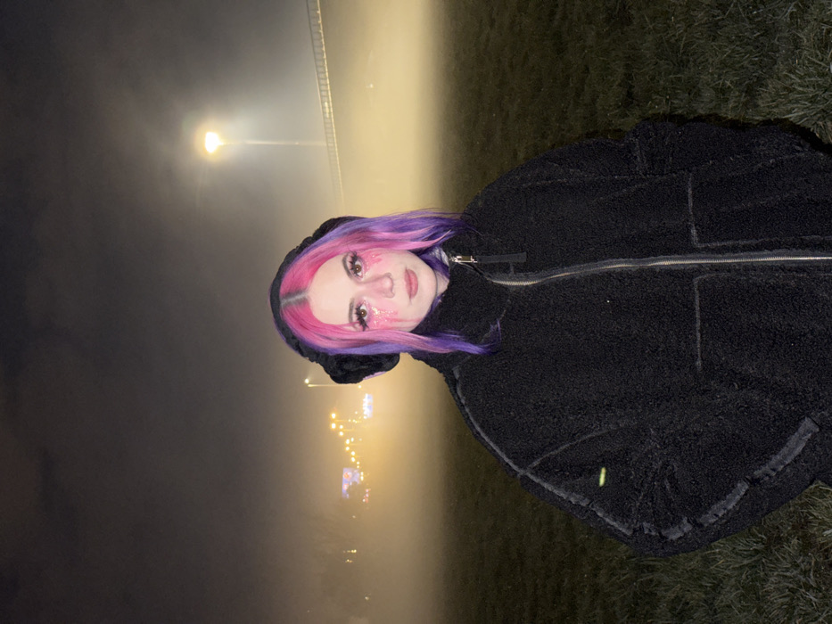 Woman with colorful hair walks through foggy Zagreb night