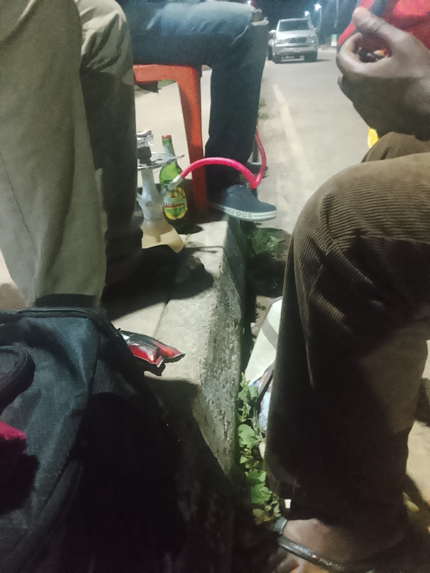 Late-night hangout outside a Jos bar, drinks and street life