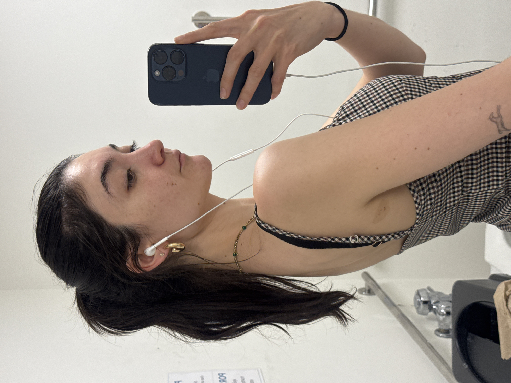 Mirror selfie session in a New York restroom, multiple angles