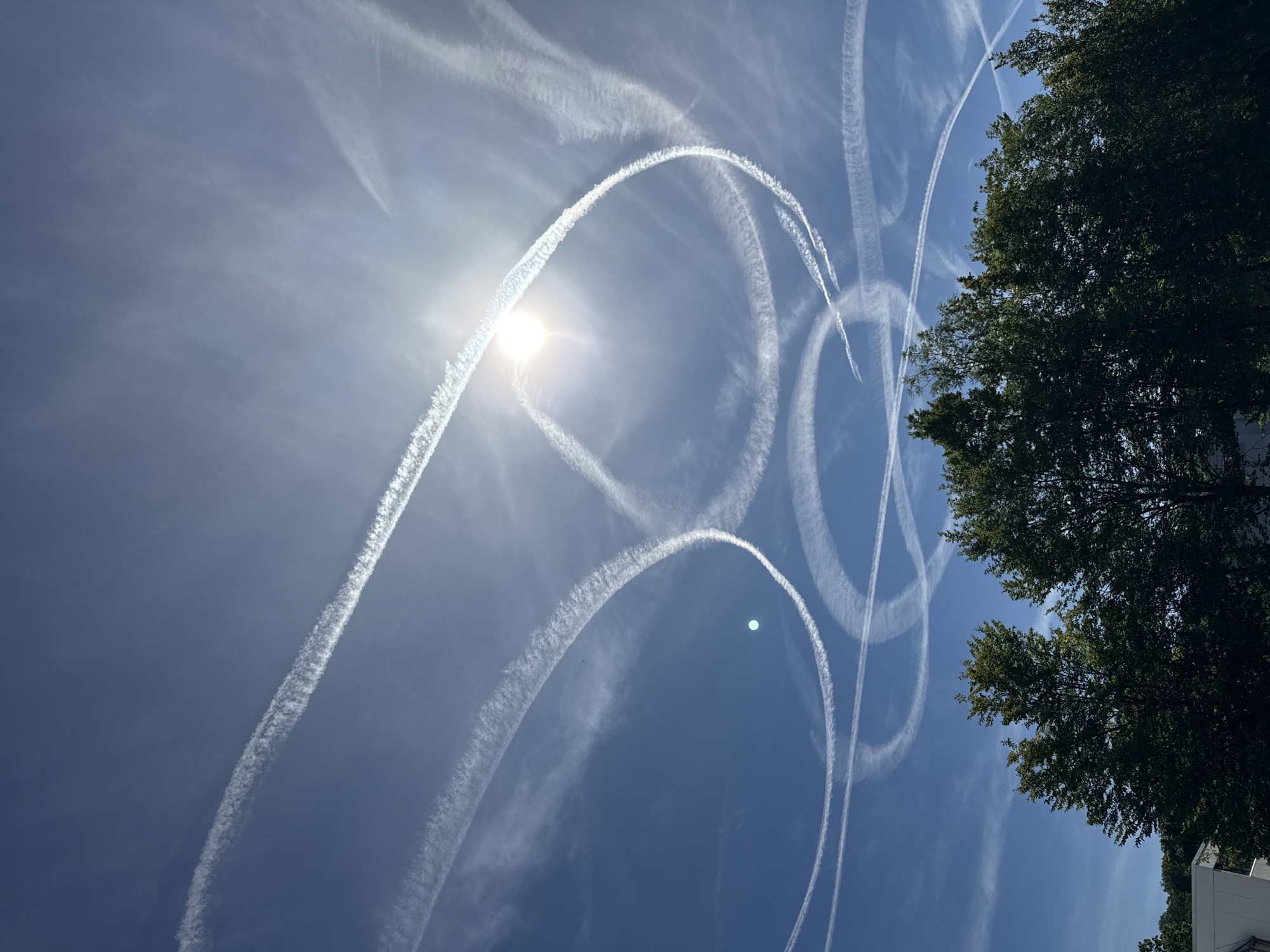 Skies over Salach laced with contrail patterns on clear morning