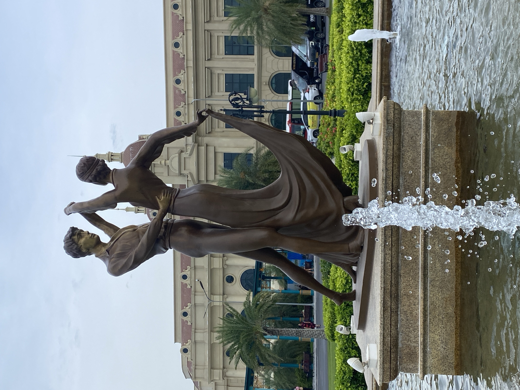 Nha Trang resort complex with fountain, wet flowers, and classical architecture