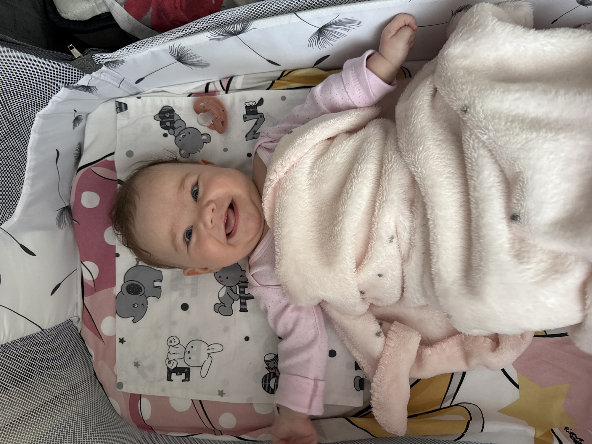 Baby observed smiling in cot in Pleven, Bulgaria