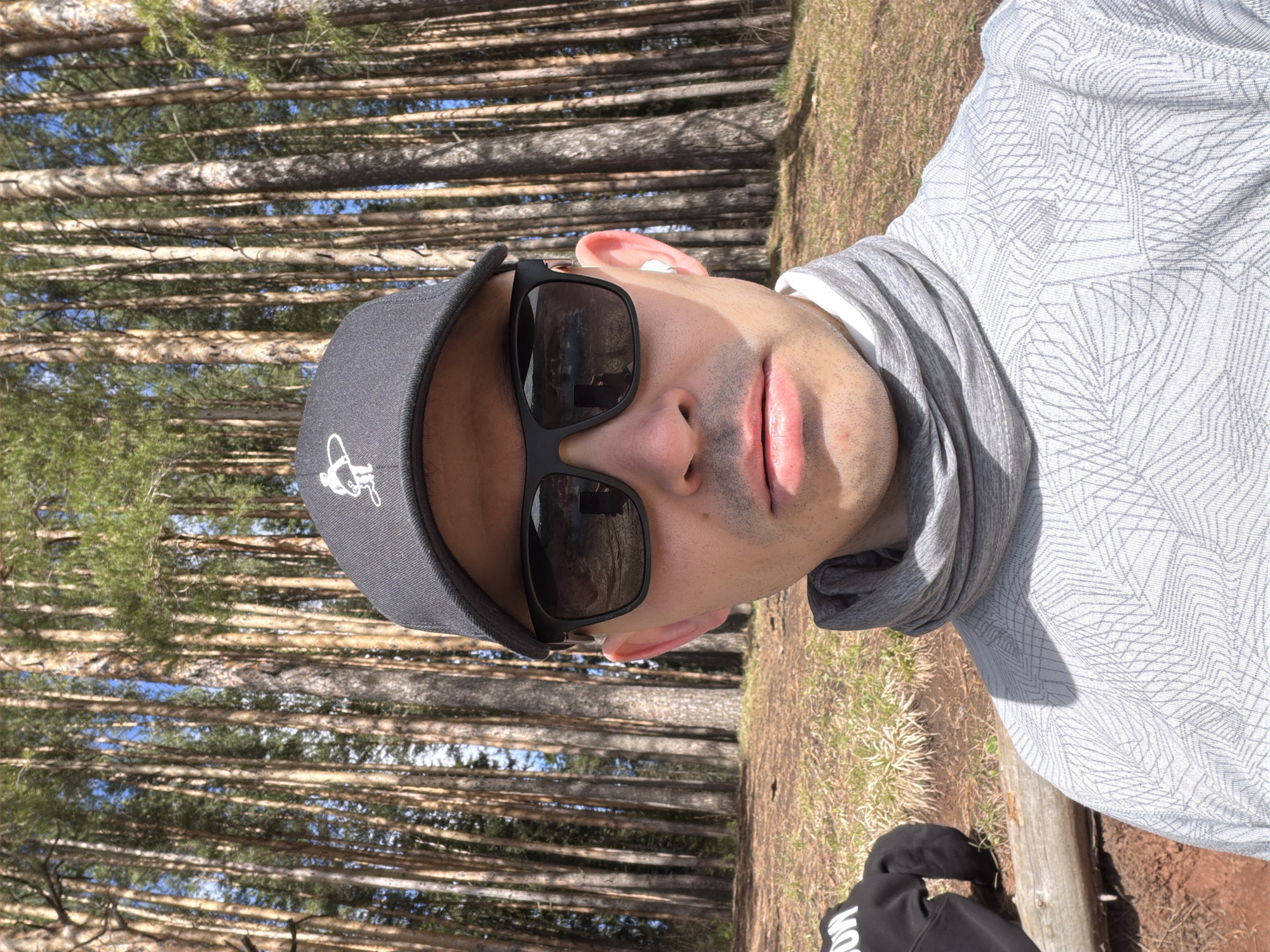 Man takes forest selfie under partly cloudy sky in Izhevsk