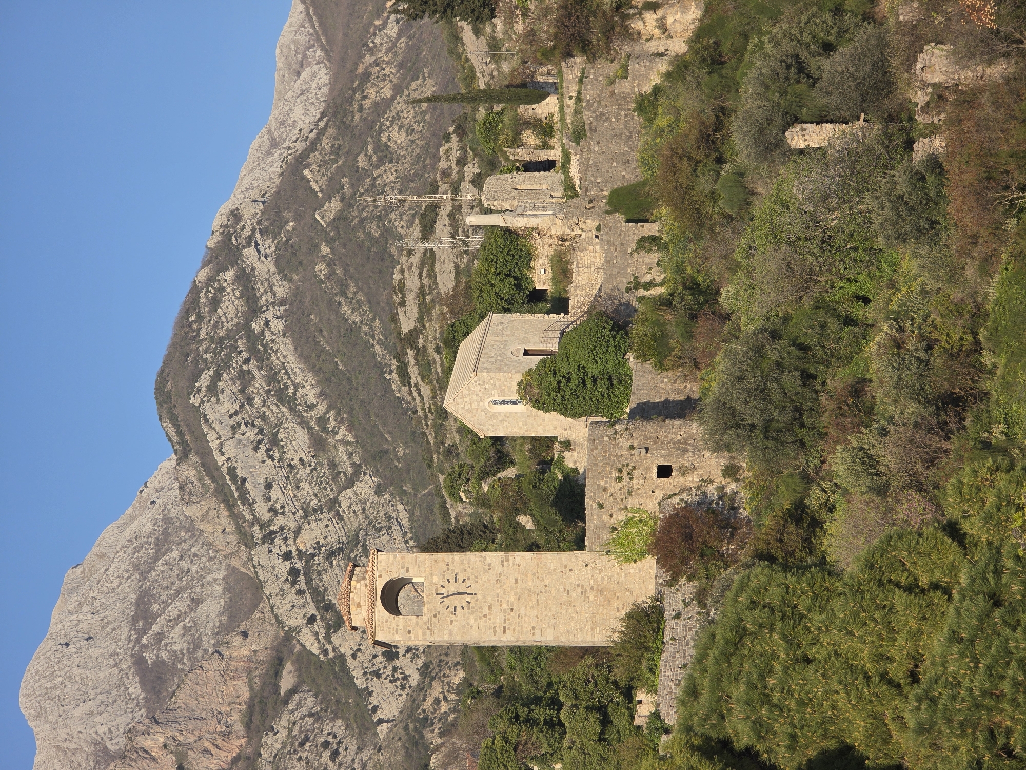Tourist documents ancient ruins and clock tower in Stari Bar