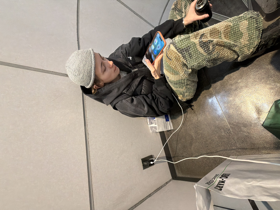 Person sits in Chuo public space, TGIF display observed