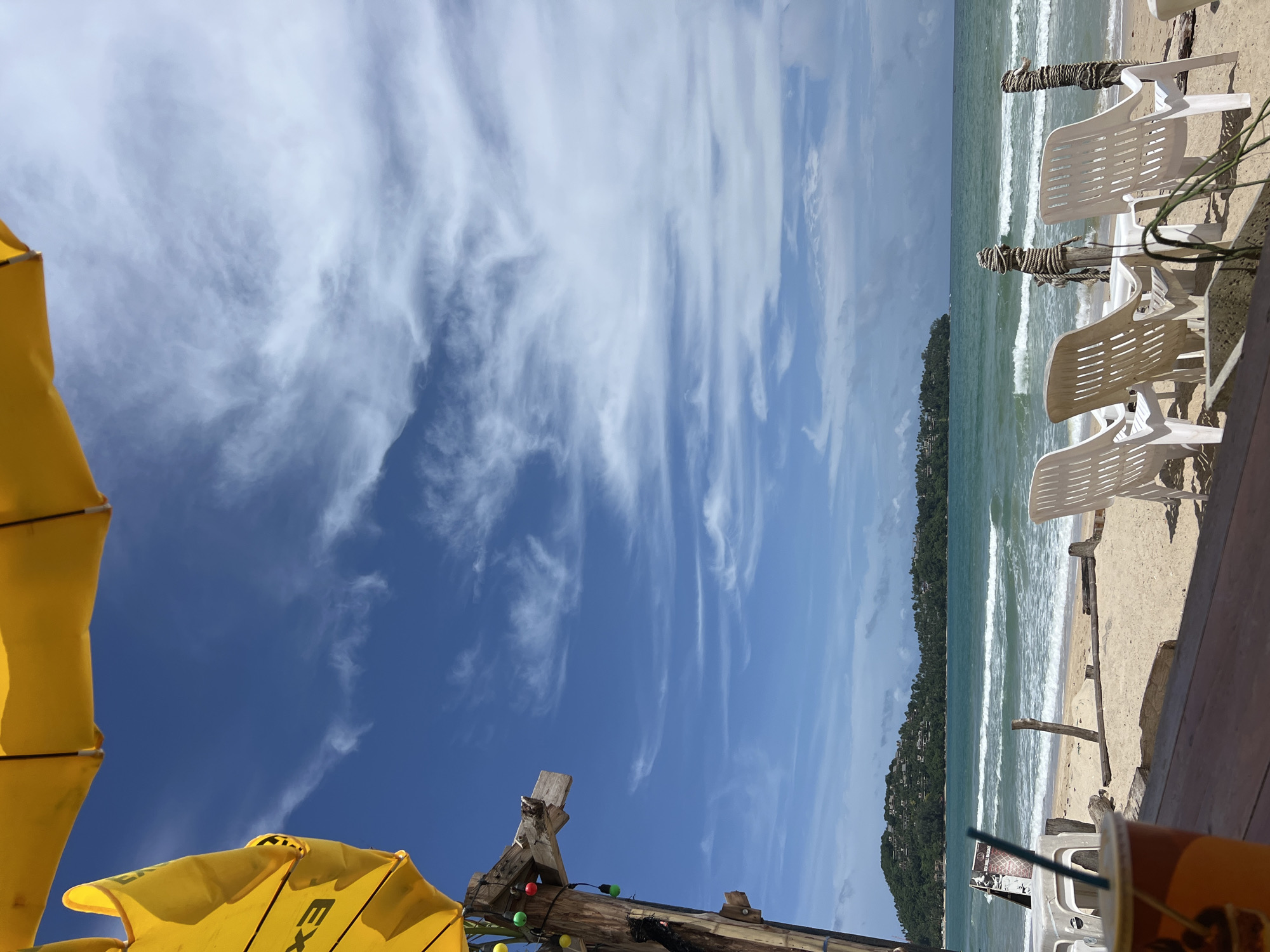 Morning beach scenes capture riders, swimmers, vendors at coastal location