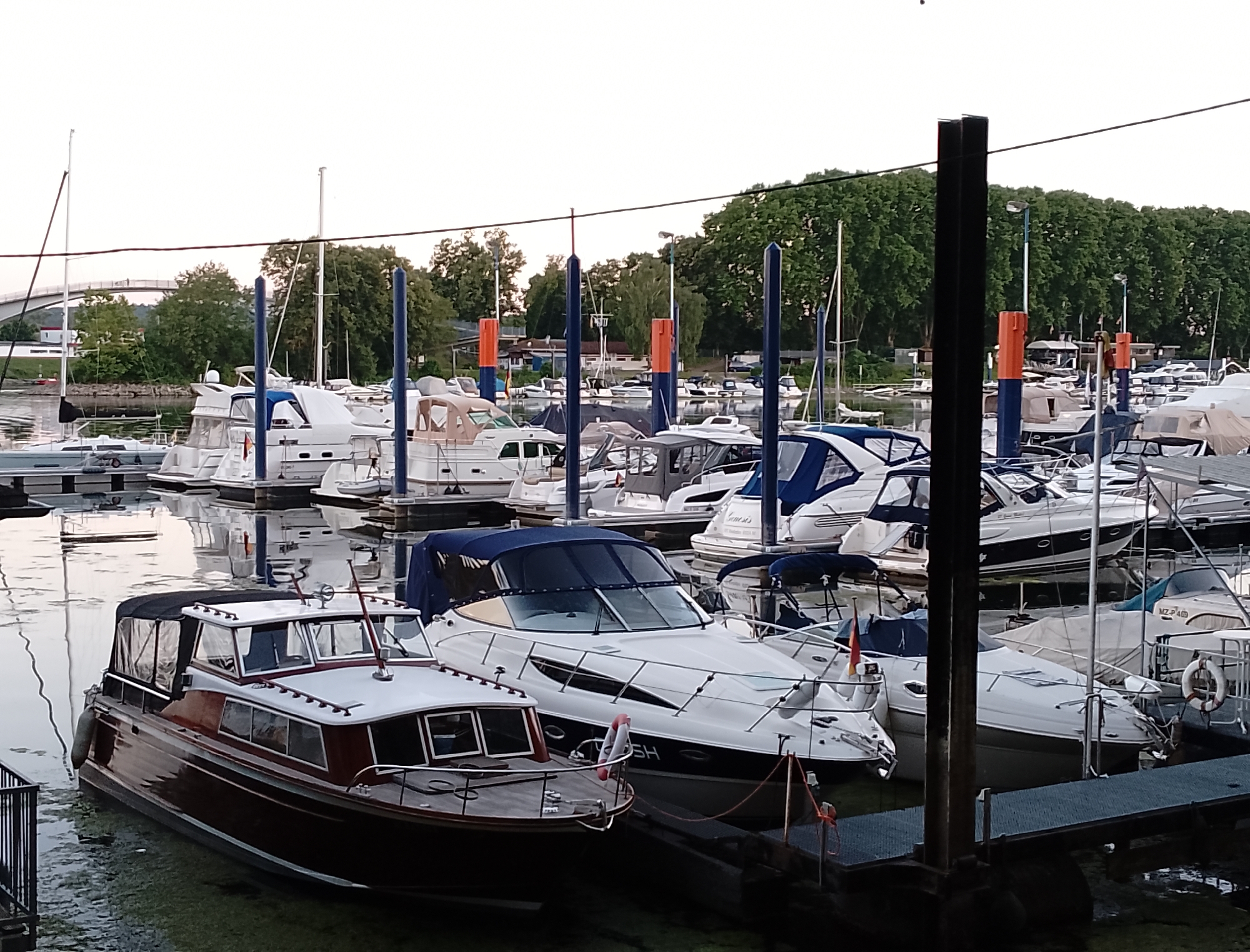 Marina town at dusk, boats docked and streets quiet