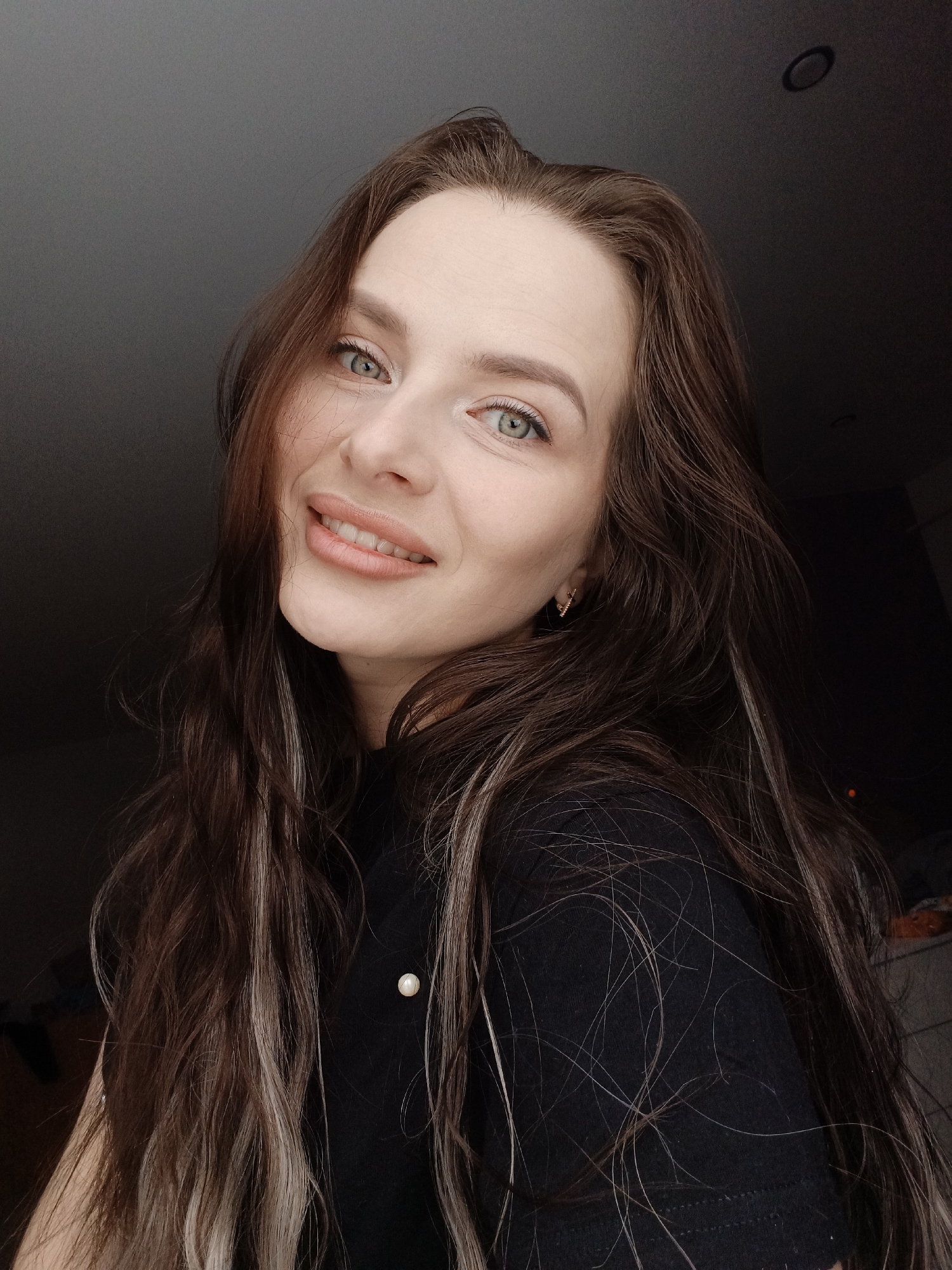 Woman photographed smiling indoors in Rusalevka, Russia