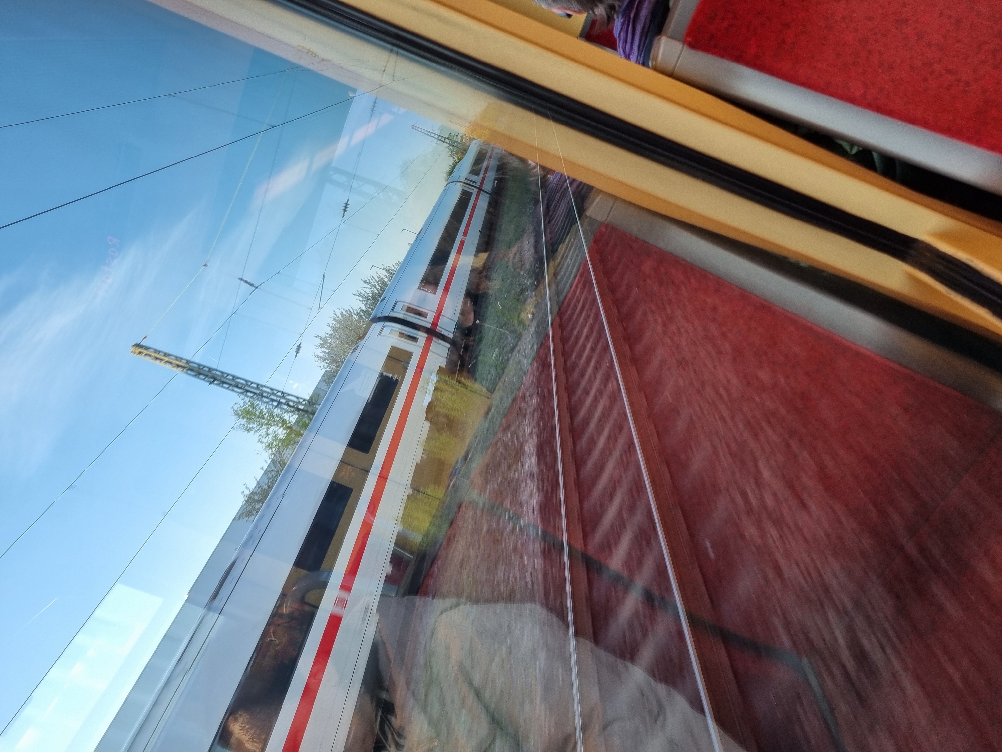 Train passenger spots passing locomotive near Ötigheim, Germany