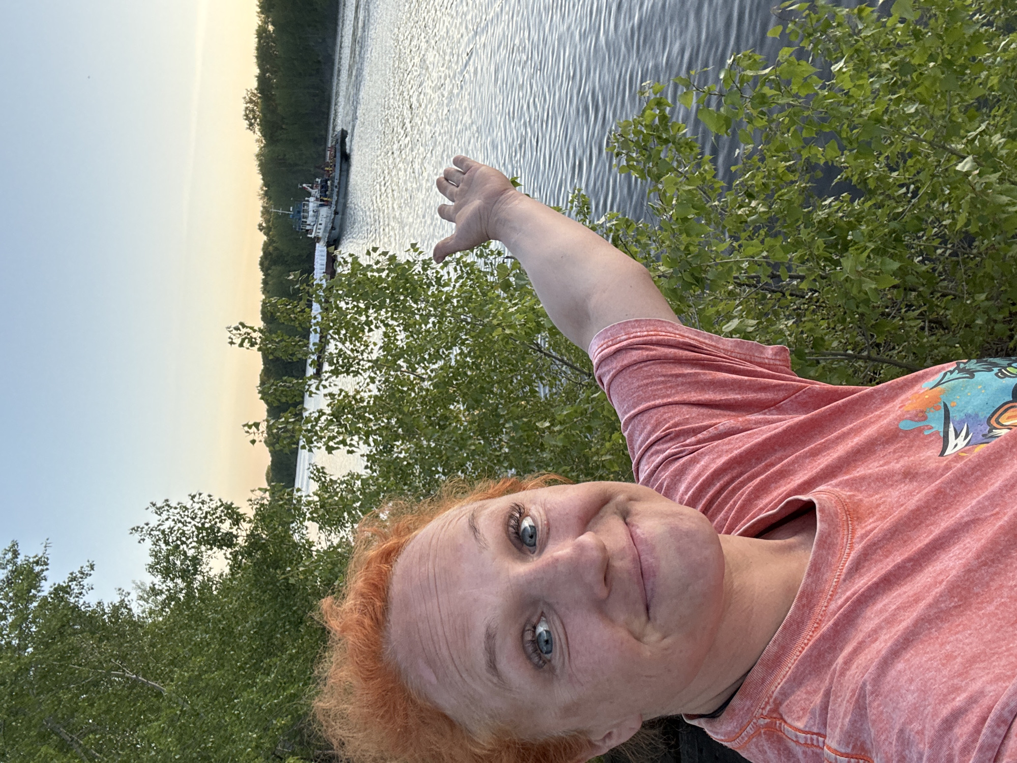 Tugboat pushes barge on Kama River near Chaikovsky