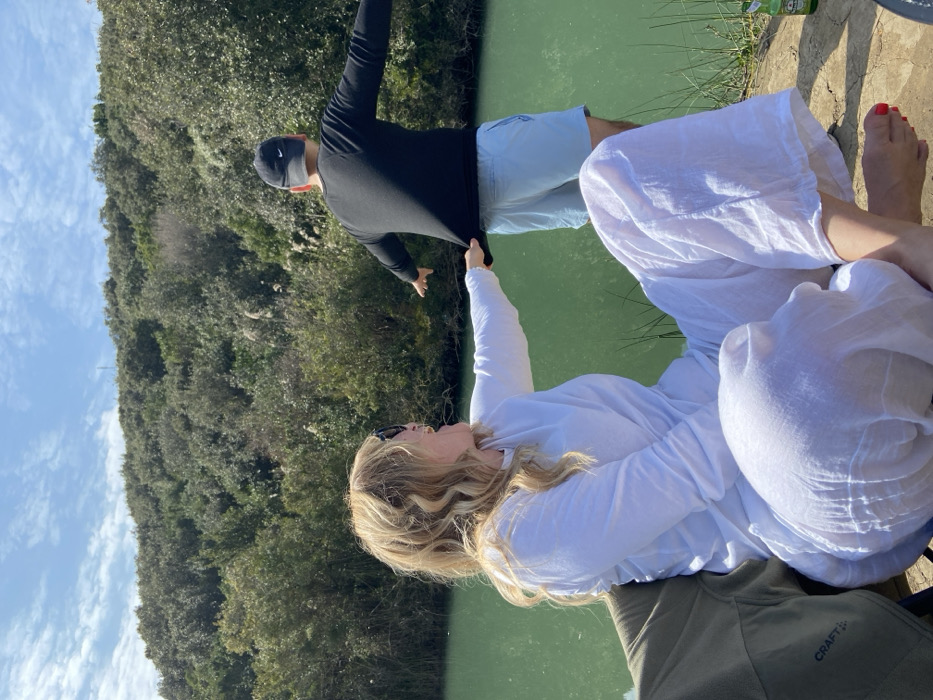 Women host riverside picnic with grilling and champagne celebration