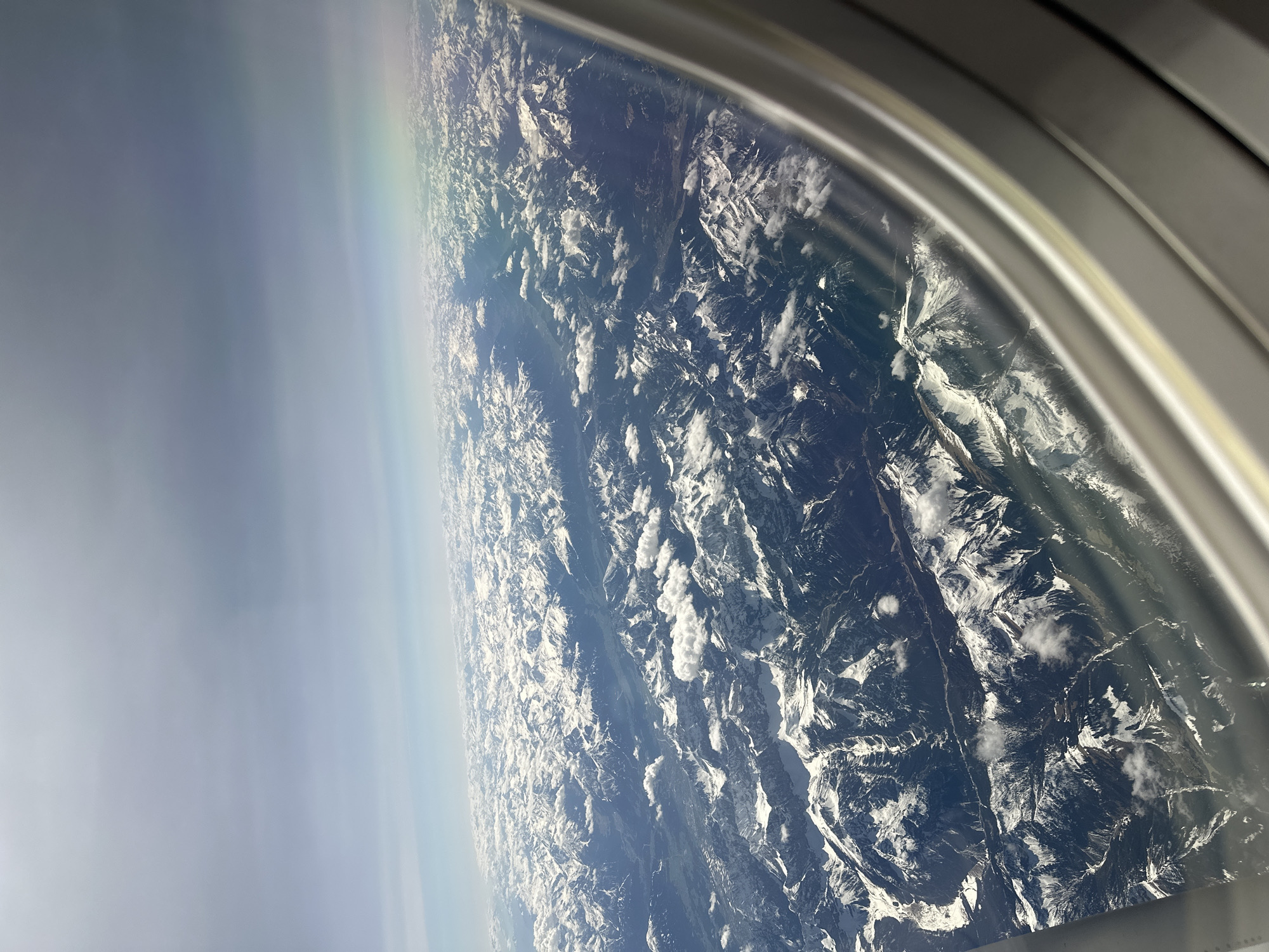 Aerial view captures snow-capped Bavarian mountains from airplane window