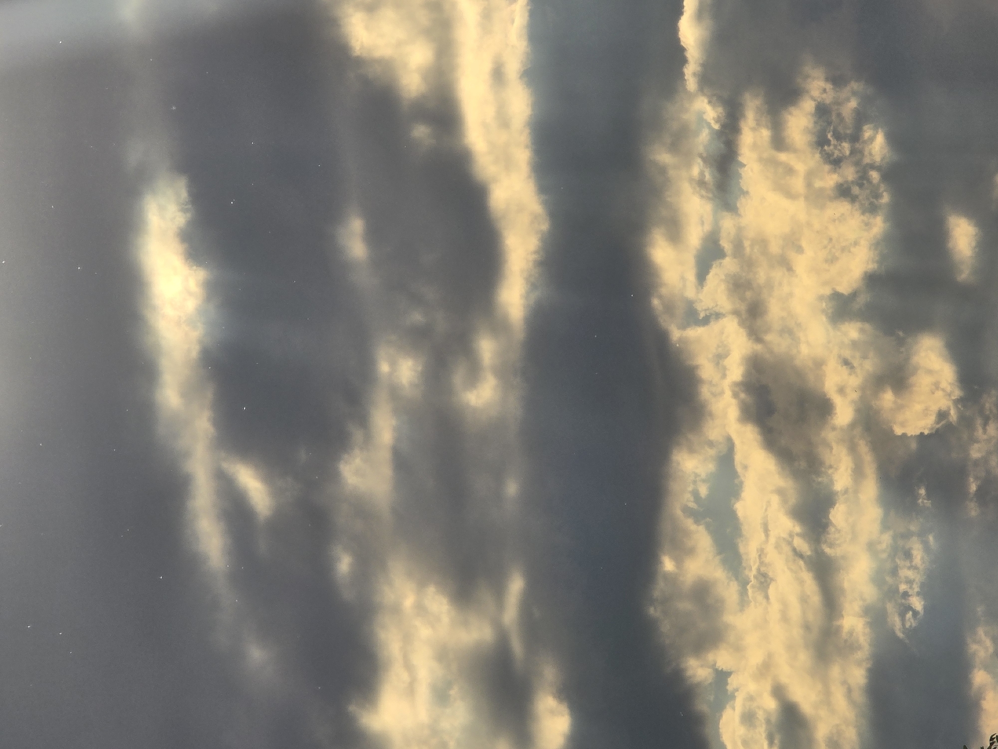 Construction crane observed against dramatic sunset clouds