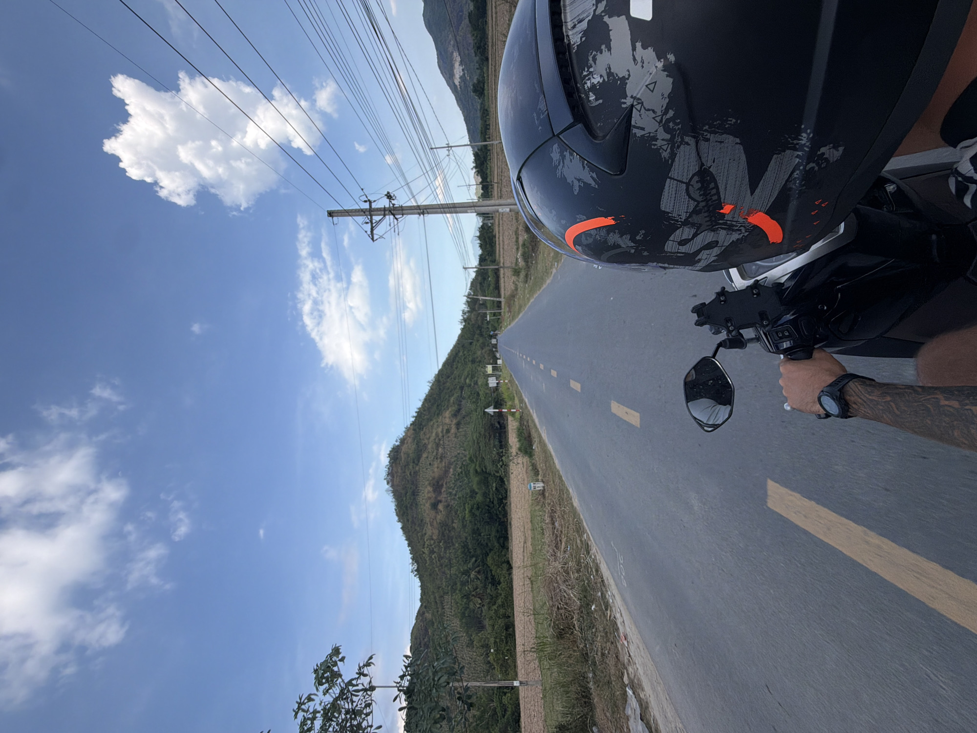Motorcyclist travels paved road in Dien Tho, Vietnam