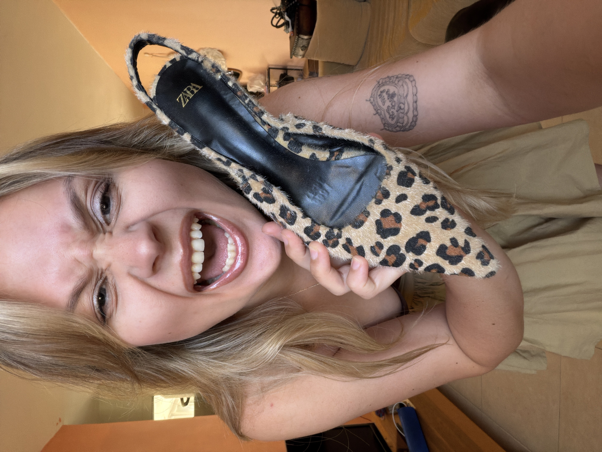 Woman tries on leopard-print shoes in Tel Aviv apartment