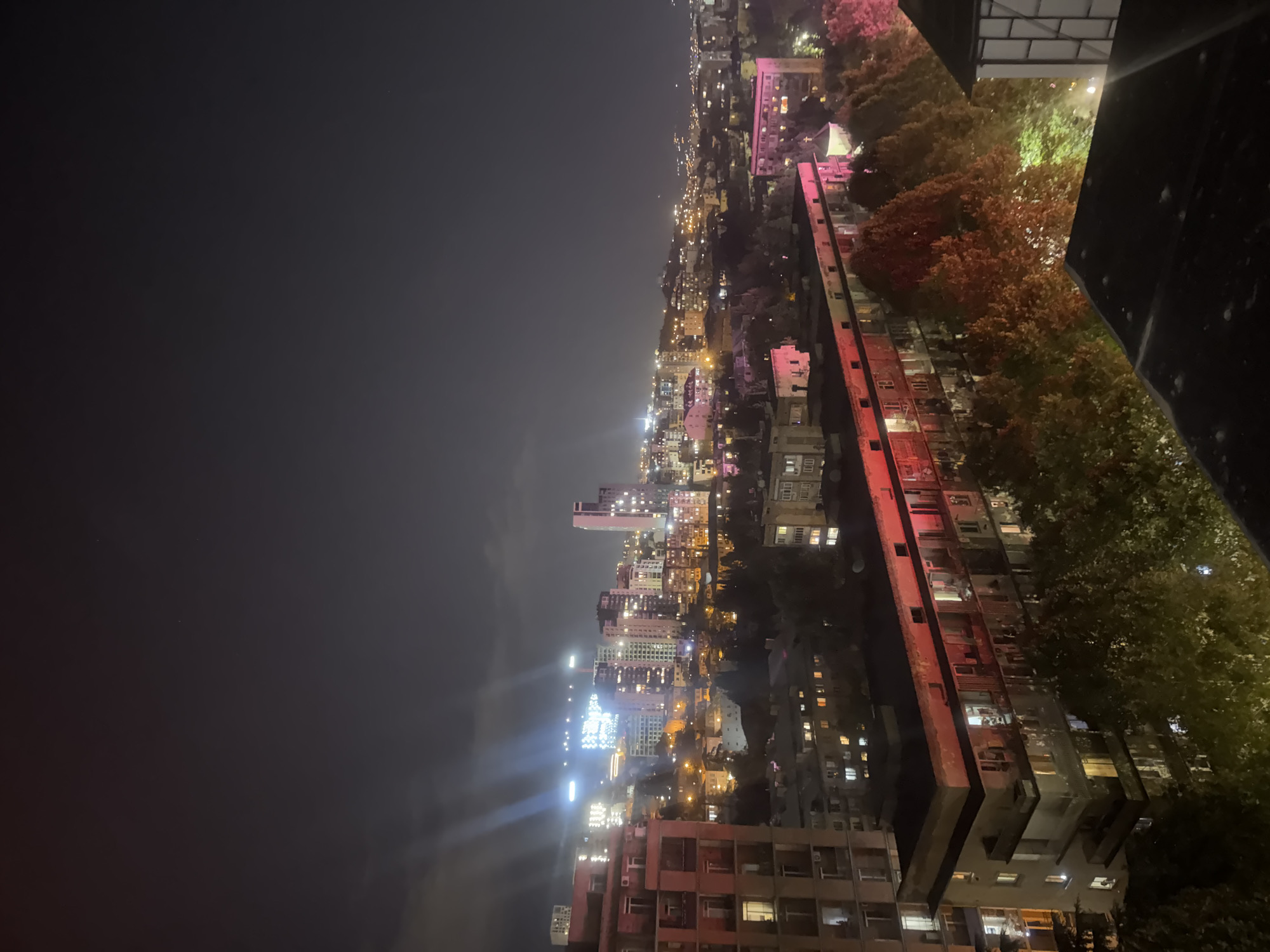 Nighttime Tbilisi skyline from an elevated residential overlook