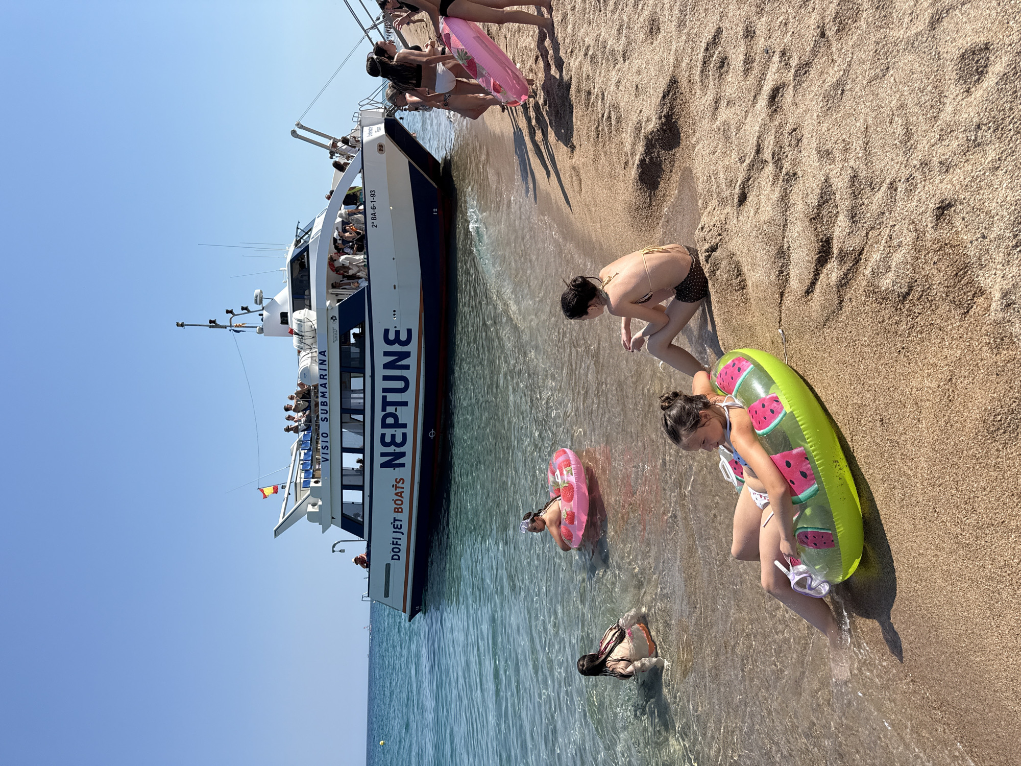 Neptune glass-bottom tour boat active at Blanes beach