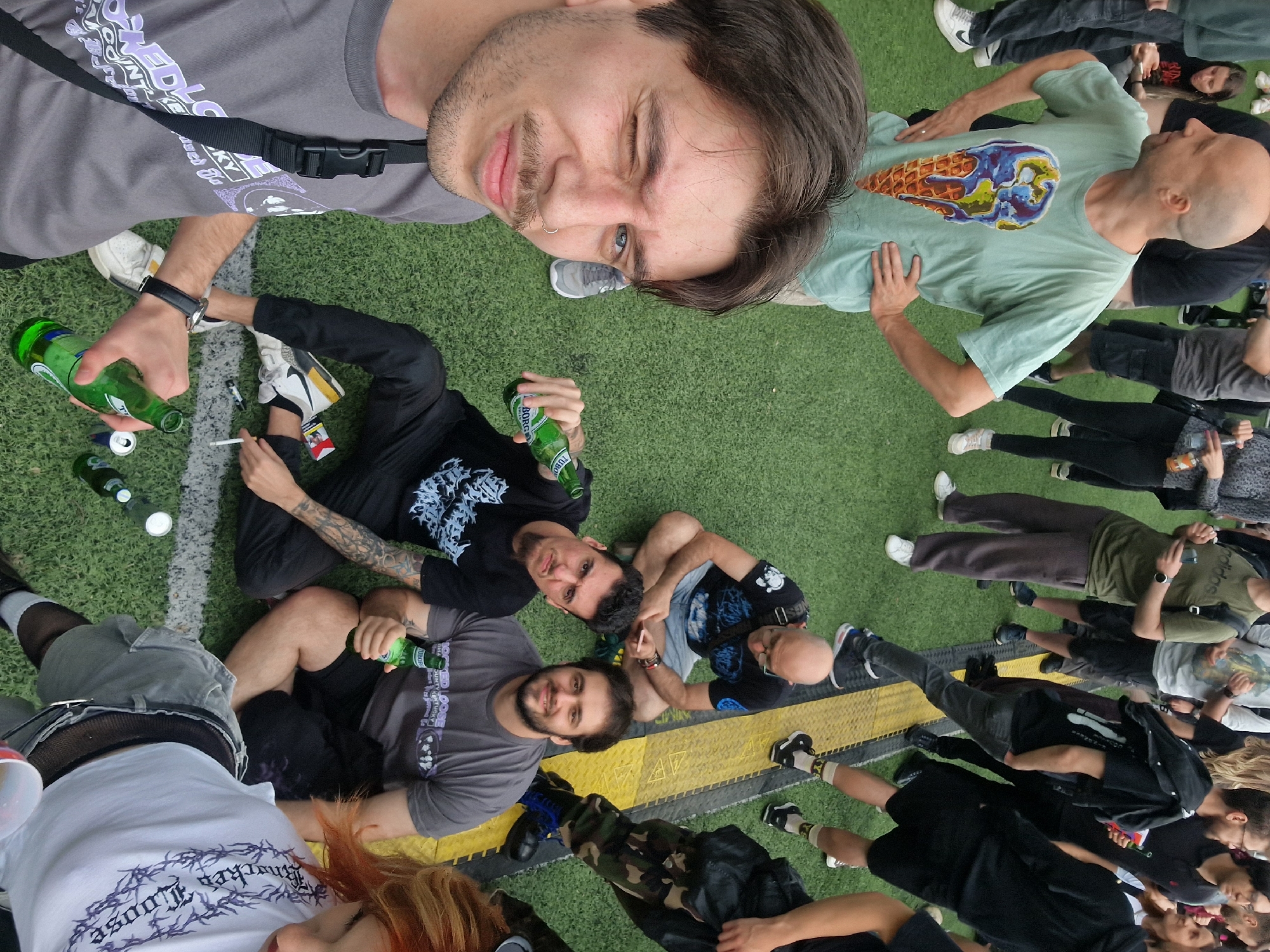 Group of 20 gathers on turf field during afternoon event