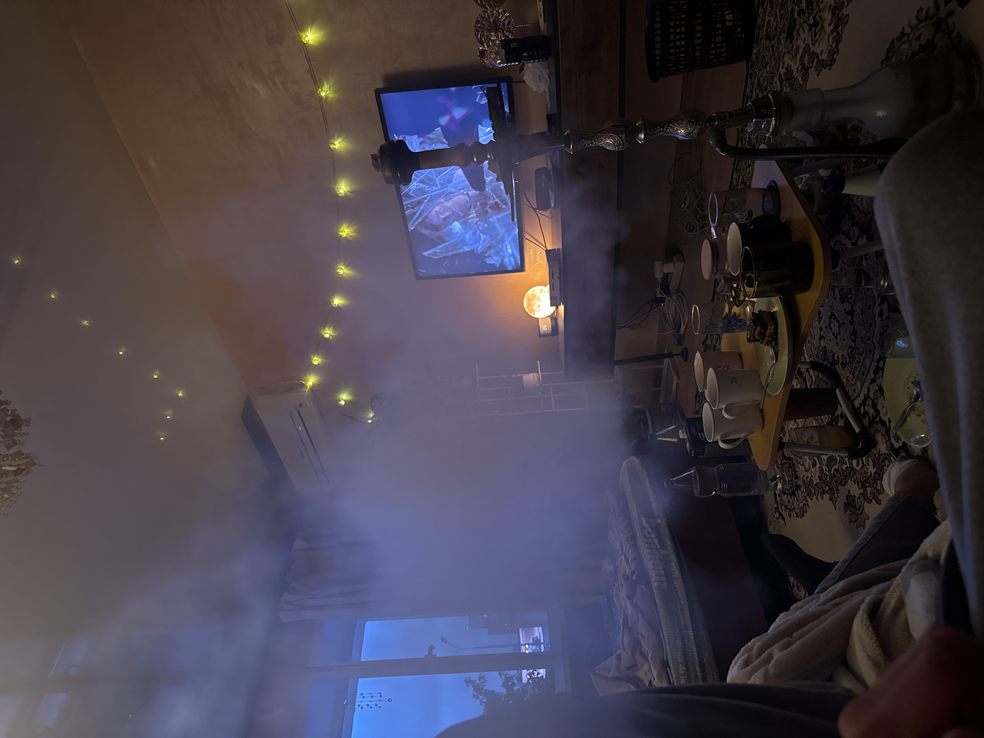 Man relaxes with vape, TV in Perm apartment