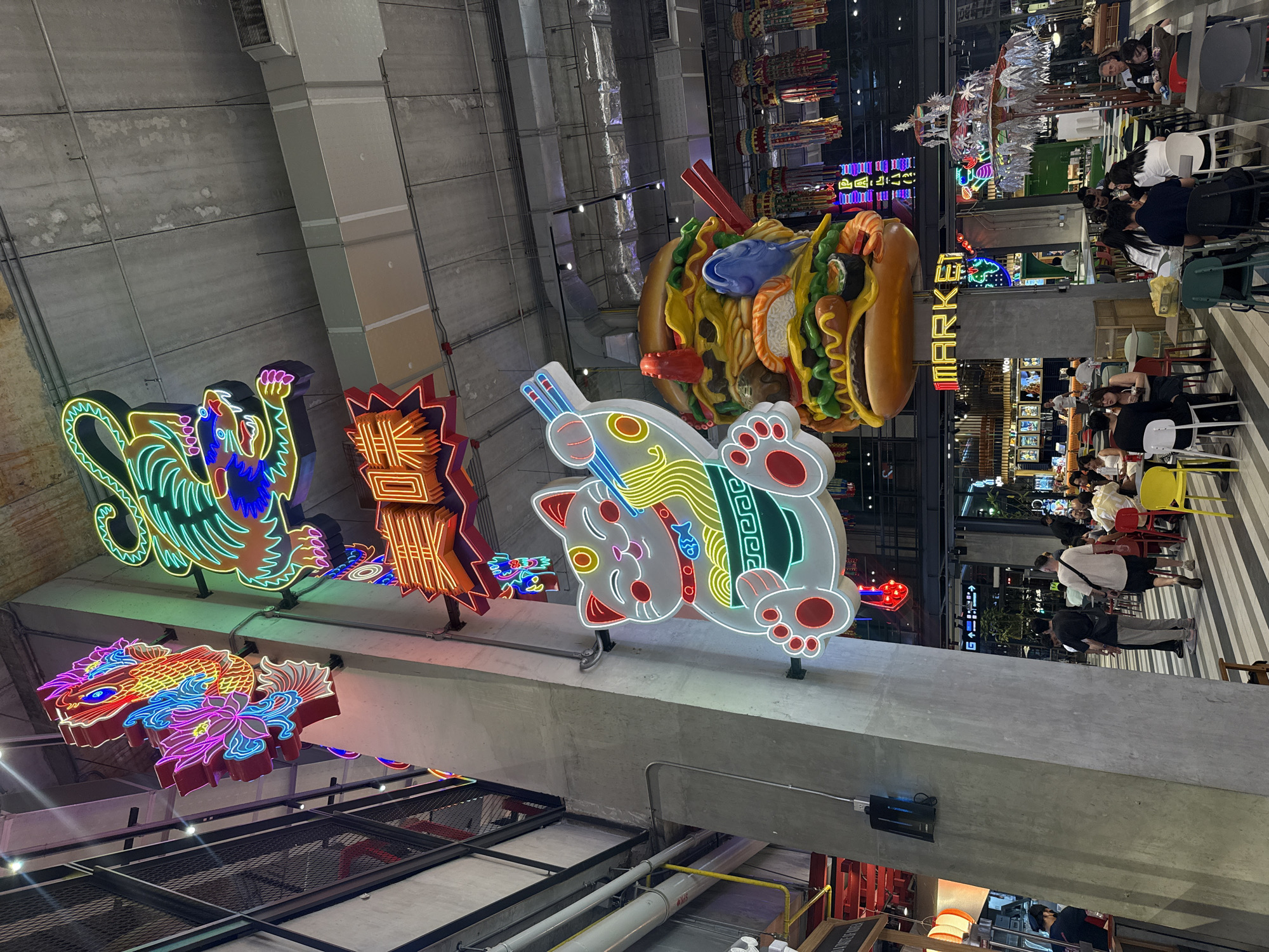 Bangkok food market displays colorful Asian neon signage