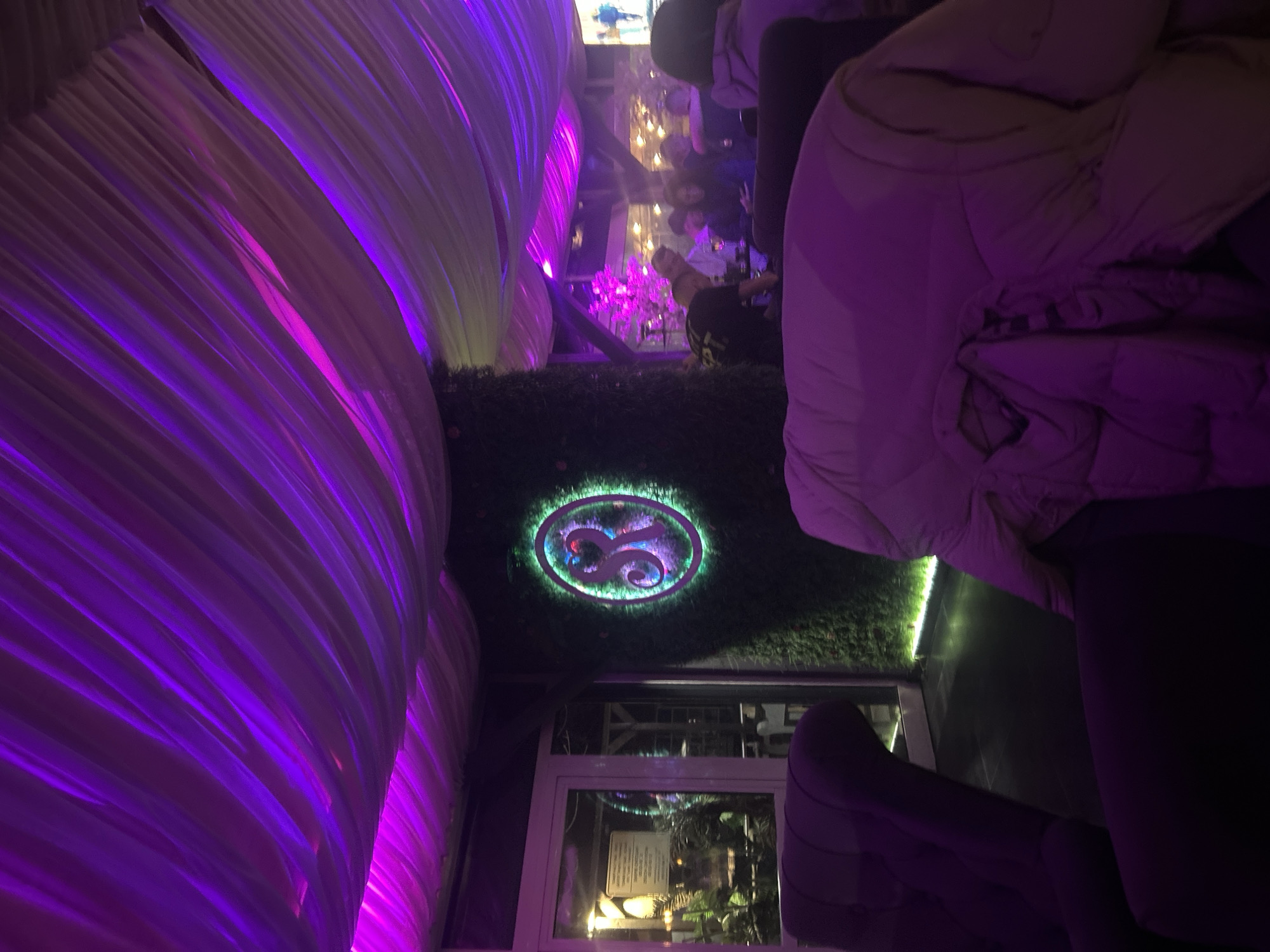 Nightclub interior captured in Zlatograd with purple lighting, draped decor