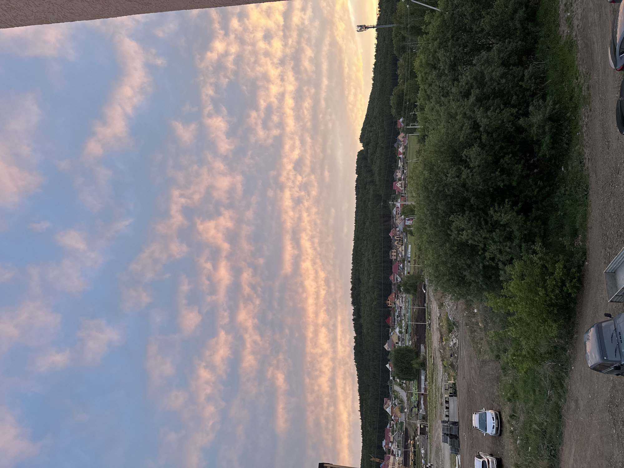 Dramatic sunset photographed over unknown hillside town Friday evening