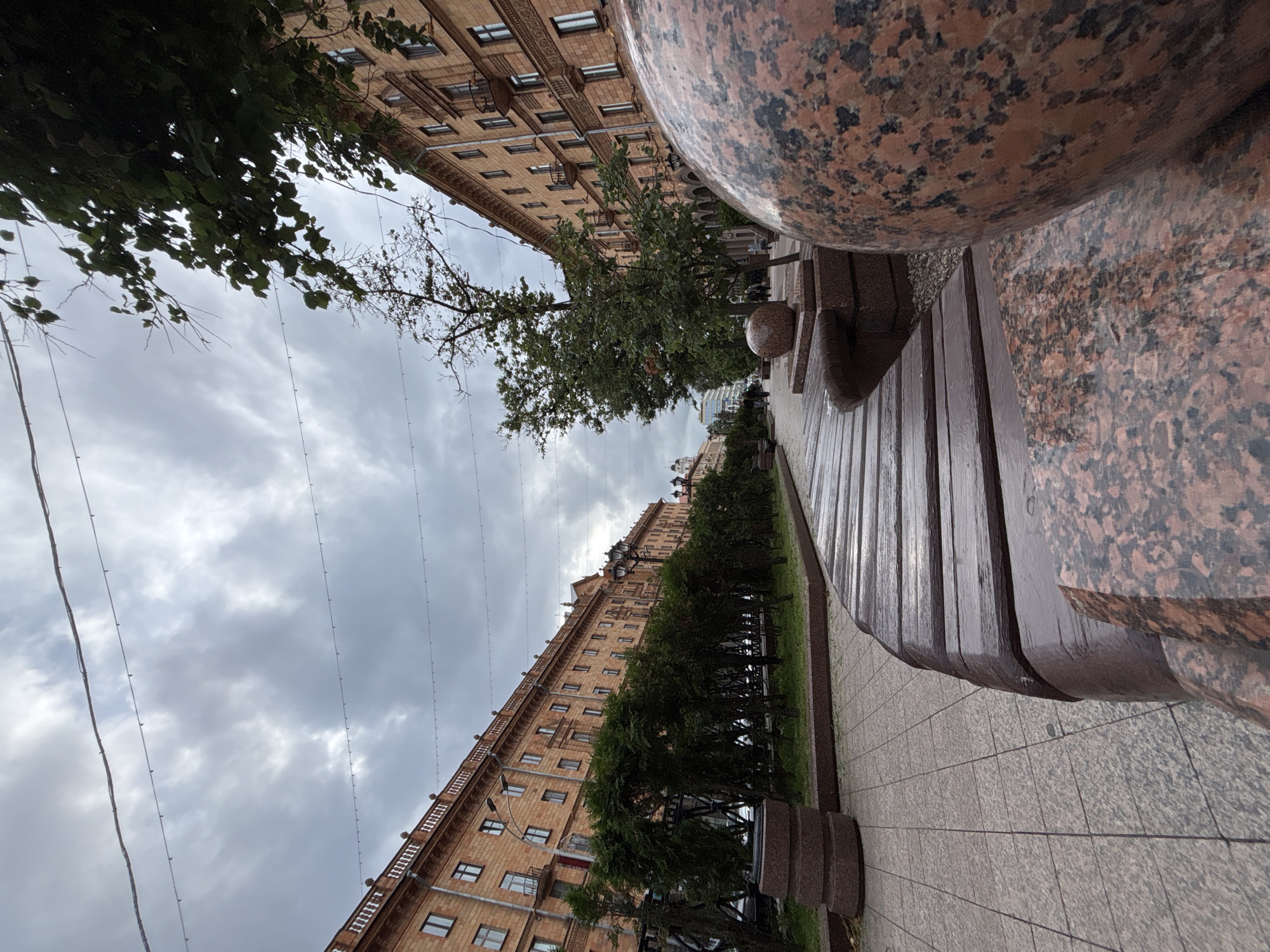 Exploring an ornate historic city center with trams and horse sculptures