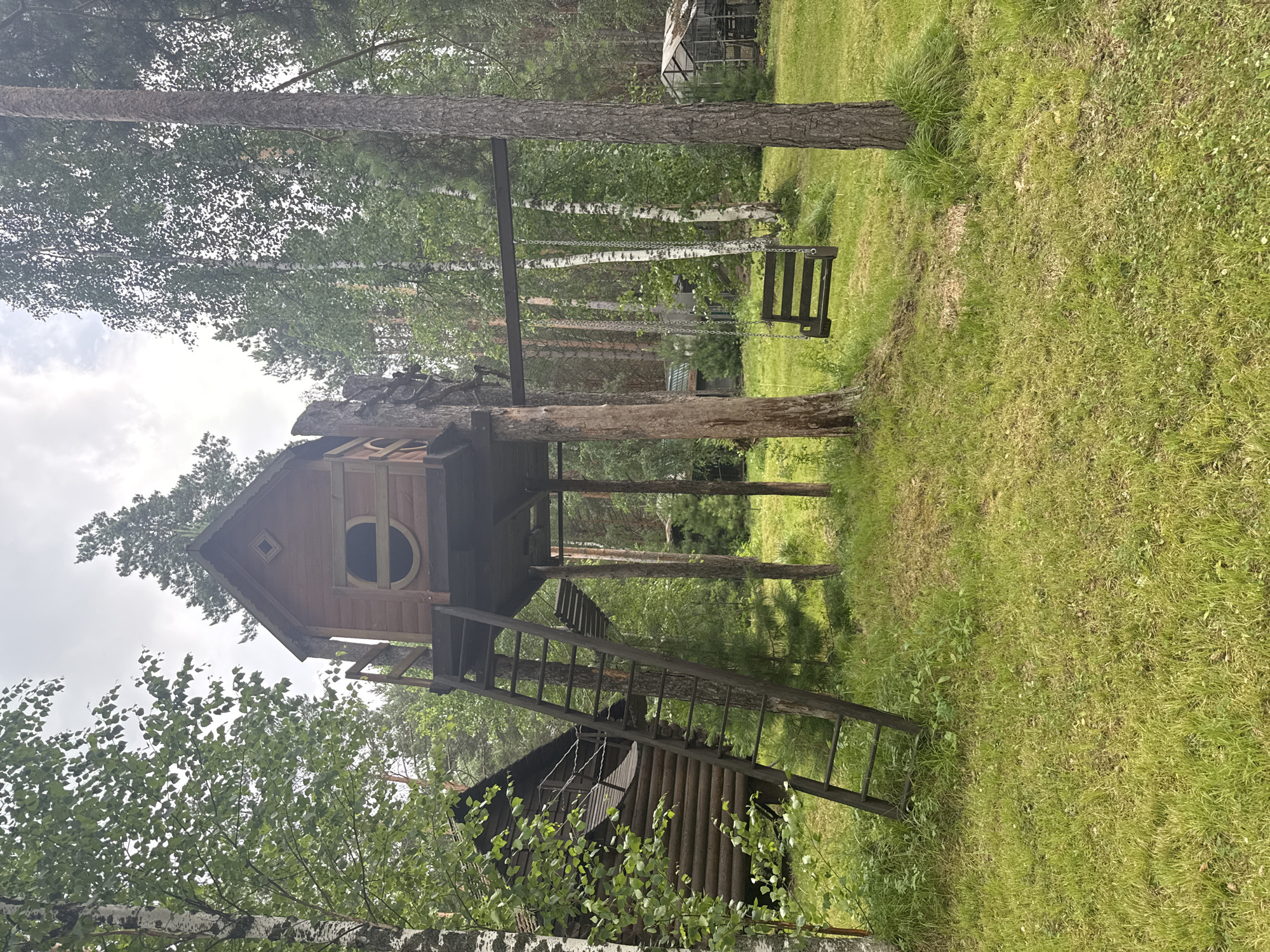 A well-kept rural Russian homestead in full summer bloom
