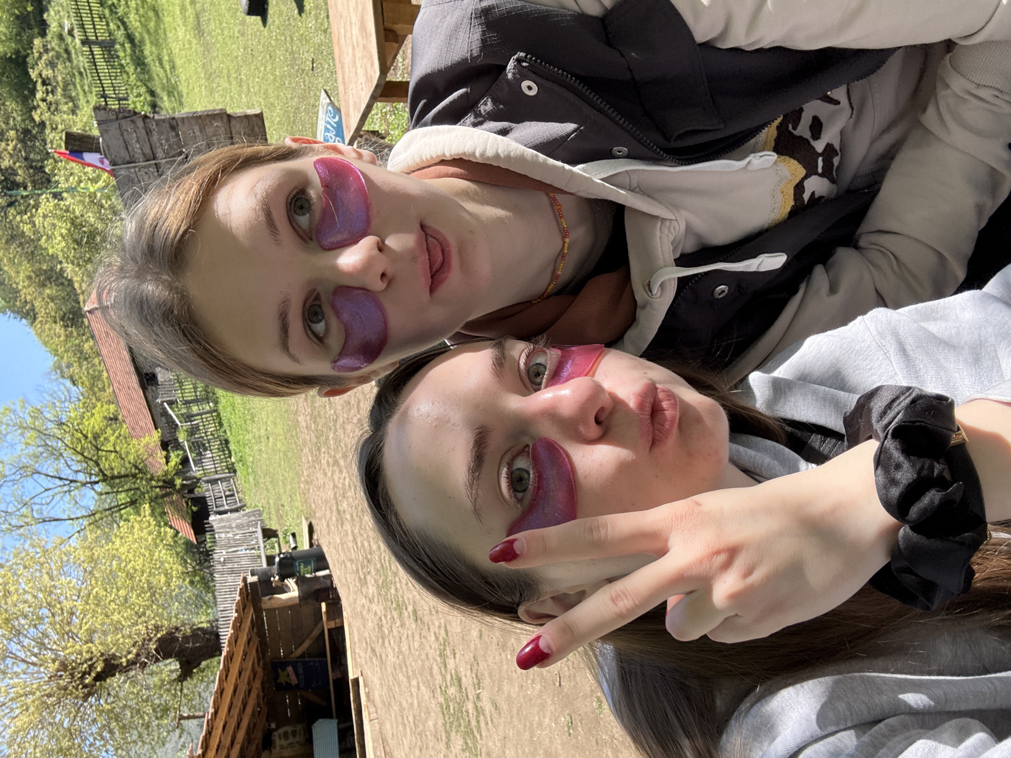 Two women pose for selfie with purple patches in Serbia