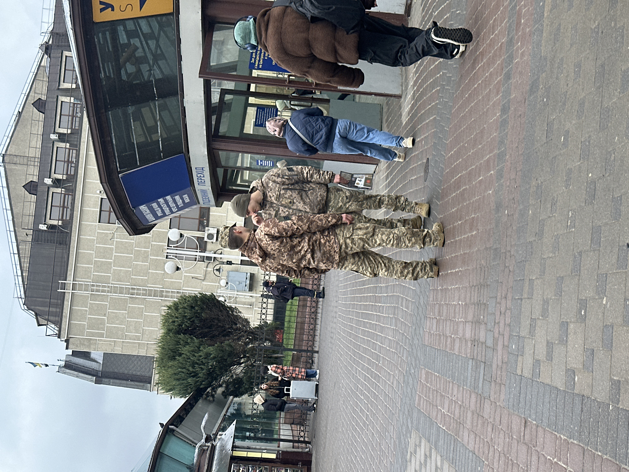 Morning conversation observed on Kyiv street sidewalk