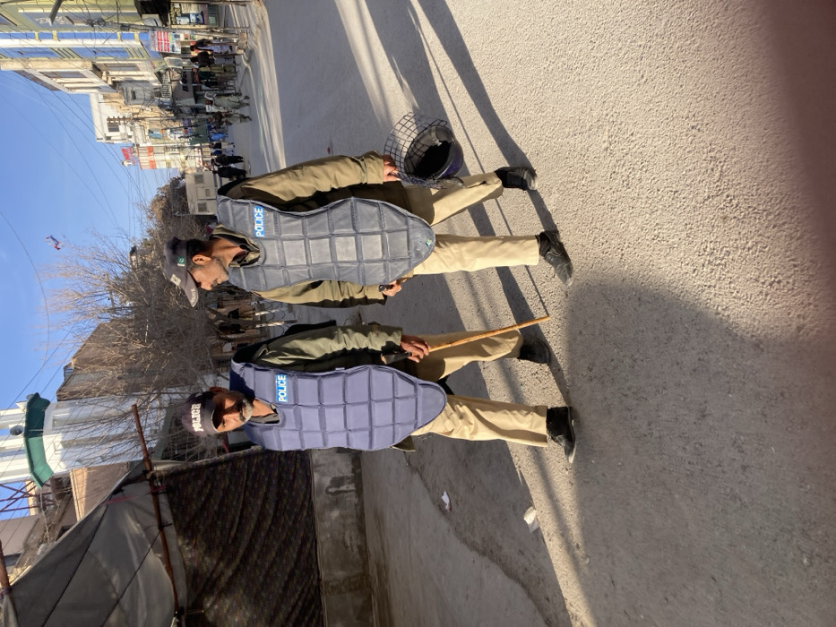 Roadside interaction between civilian and uniformed official in Quetta